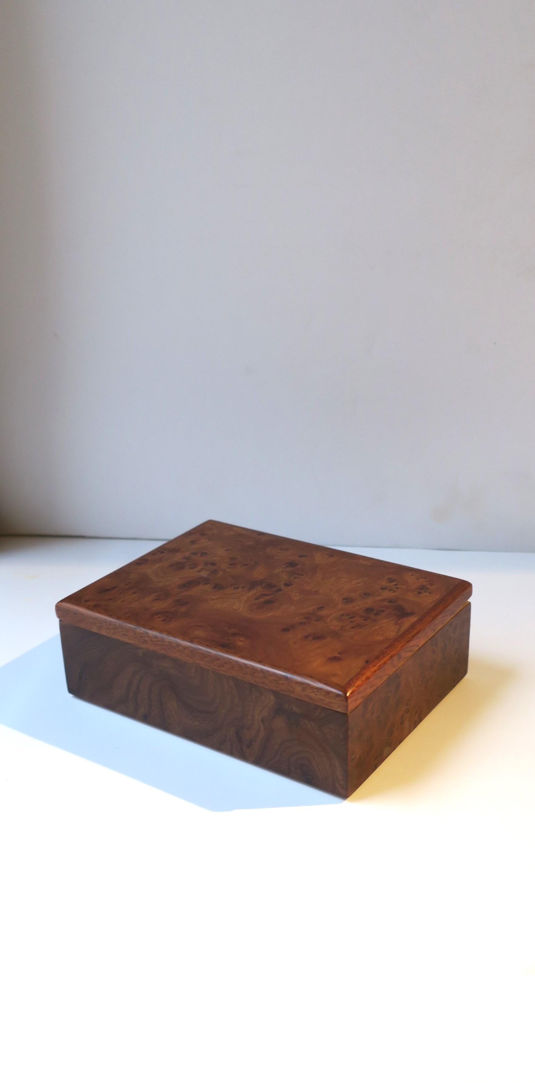 An Italian jewelry box in the modern style, circa late-20th century, Italy. Box is wood with a burl veneer and velvet lining. Box has two compartments, one for rings, cufflinks, or earrings, and the other perhaps to hold a watch, necklaces,