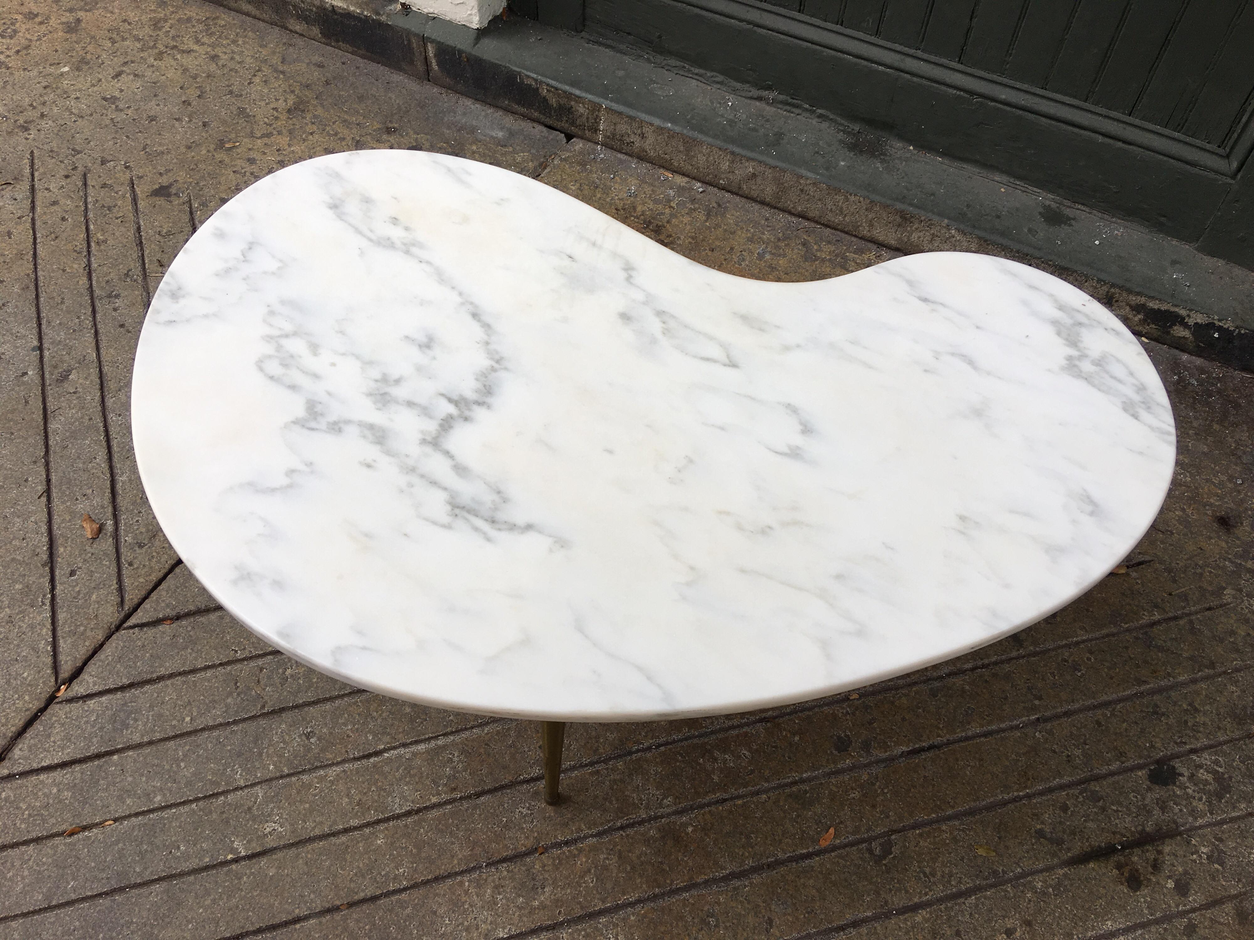 Italian marble kidney shaped three legged coffee table with brass legs. Two tables available, priced individually.