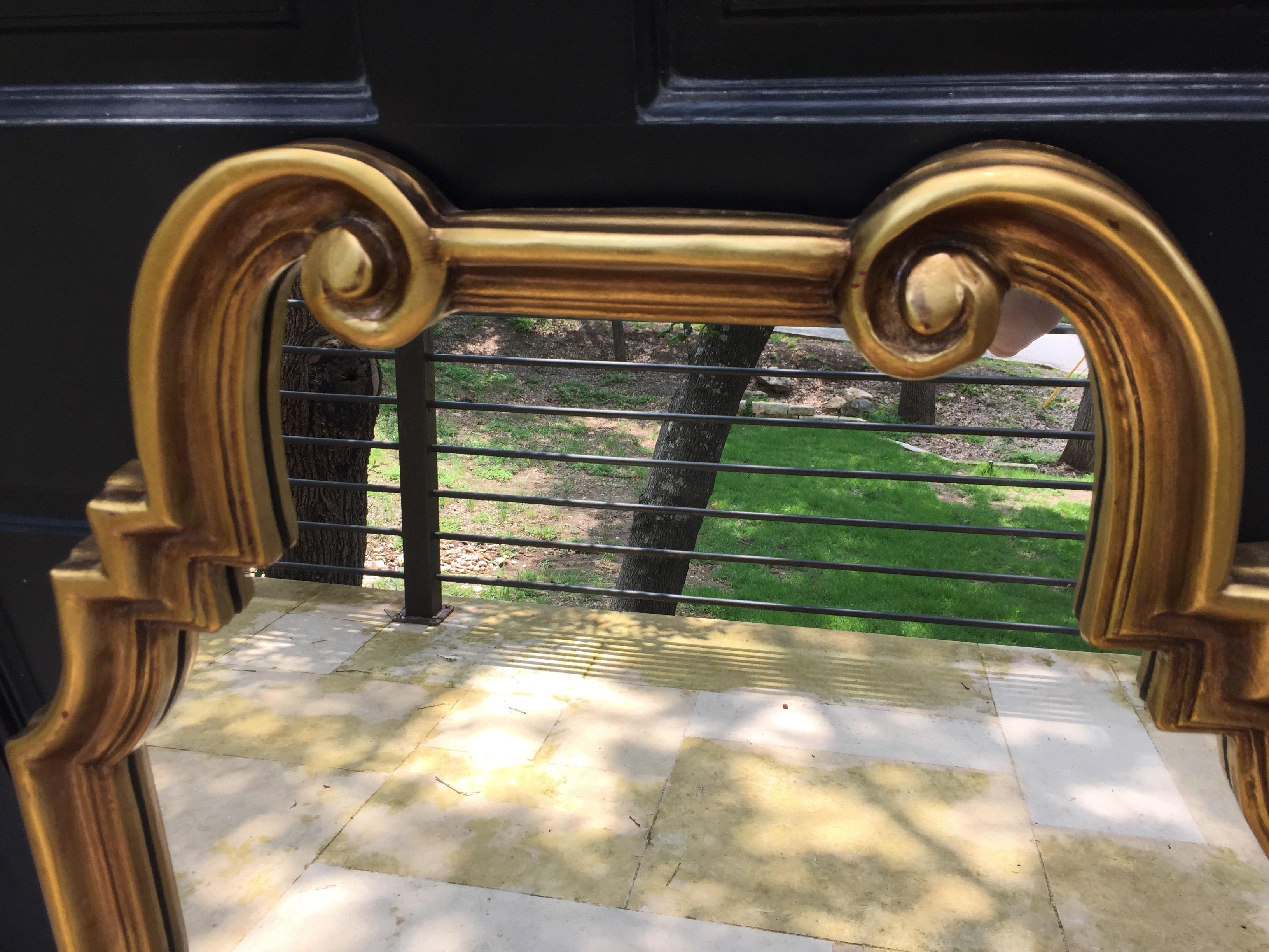 1960s La Barge wooden mirror with a gilt finish. Geometric sides lead to a scrolled top, giving this mirror transitional appeal. French style curved accents at top compliment its contemporary lines. Unmarked.