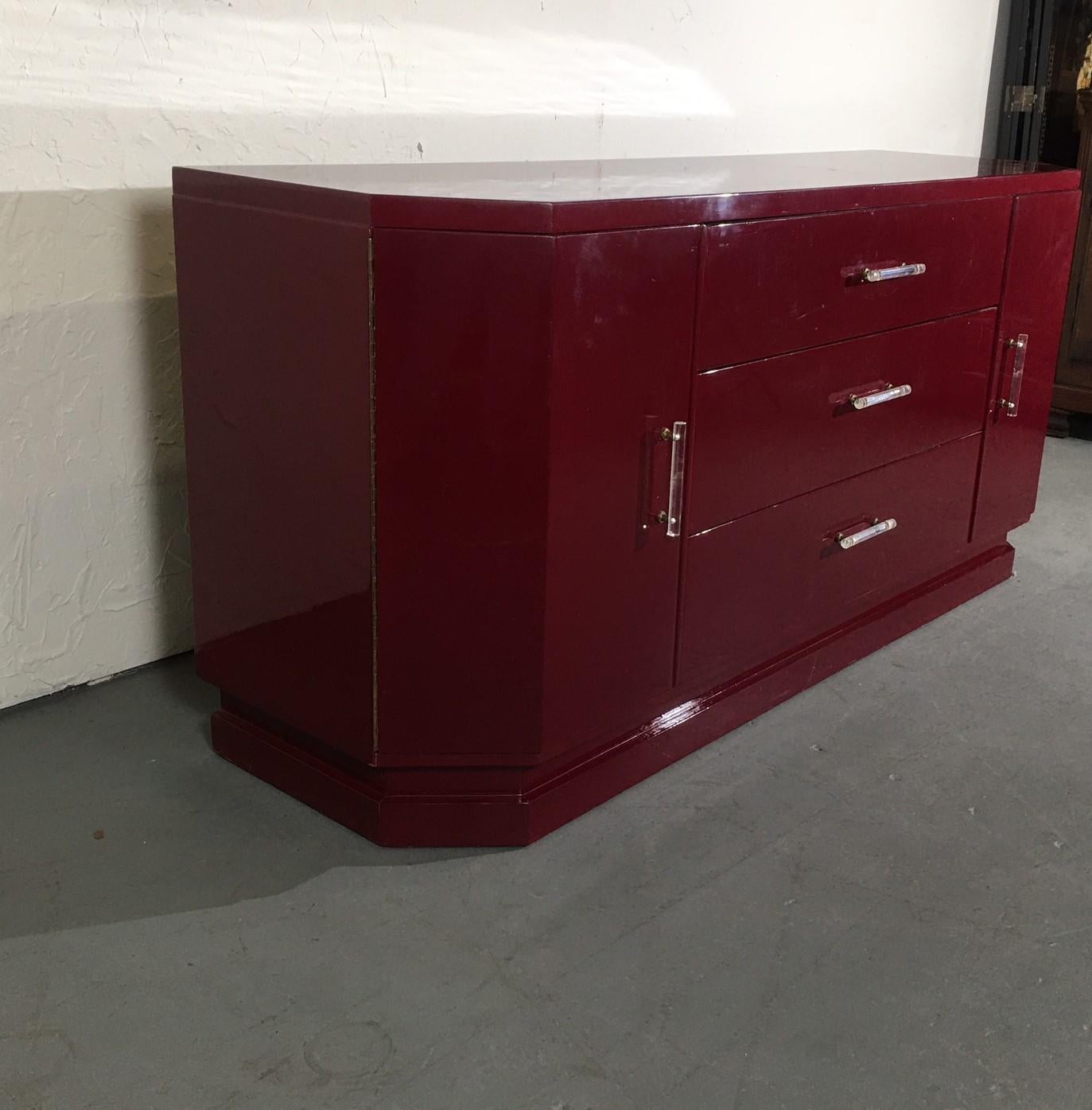 Fine quality lacquered finished Italian credenza. Beautiful rich color, clean lines with lots of storage. The handles are made of lucite.