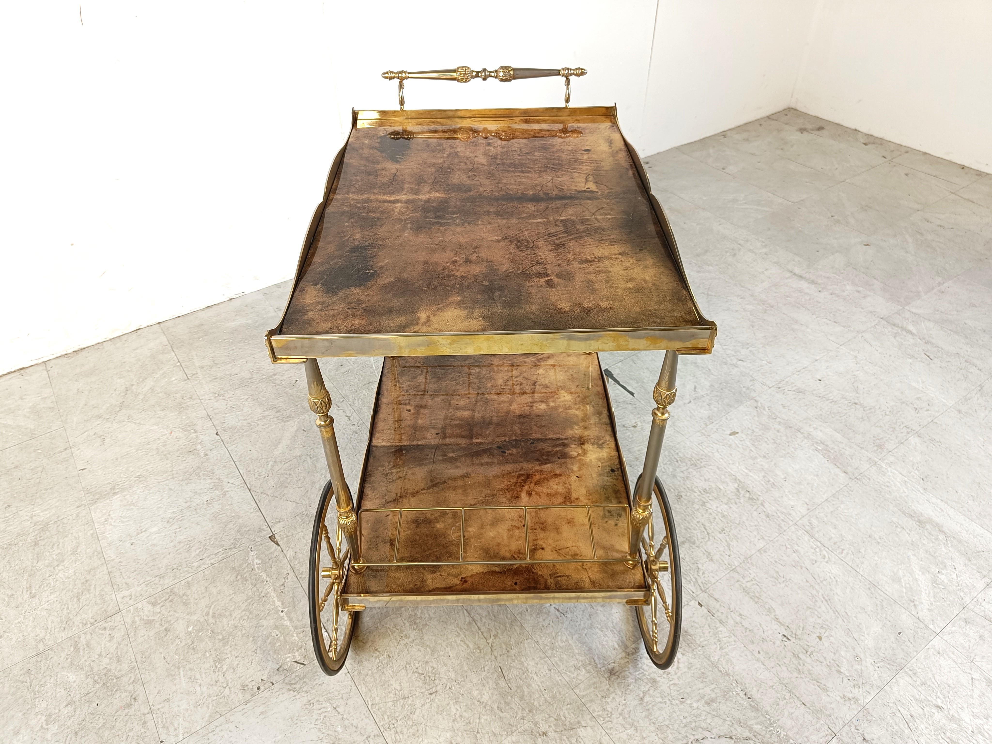 Very unique Aldo Tura Goatskin or parchment bar cart. This bar cart was made in Italy in the 1960s. 

Constructed of thickly lacquered goatskin / parchment and gilt metal hardware. 

Perfect bar or serving cart, or as rolling storage in an