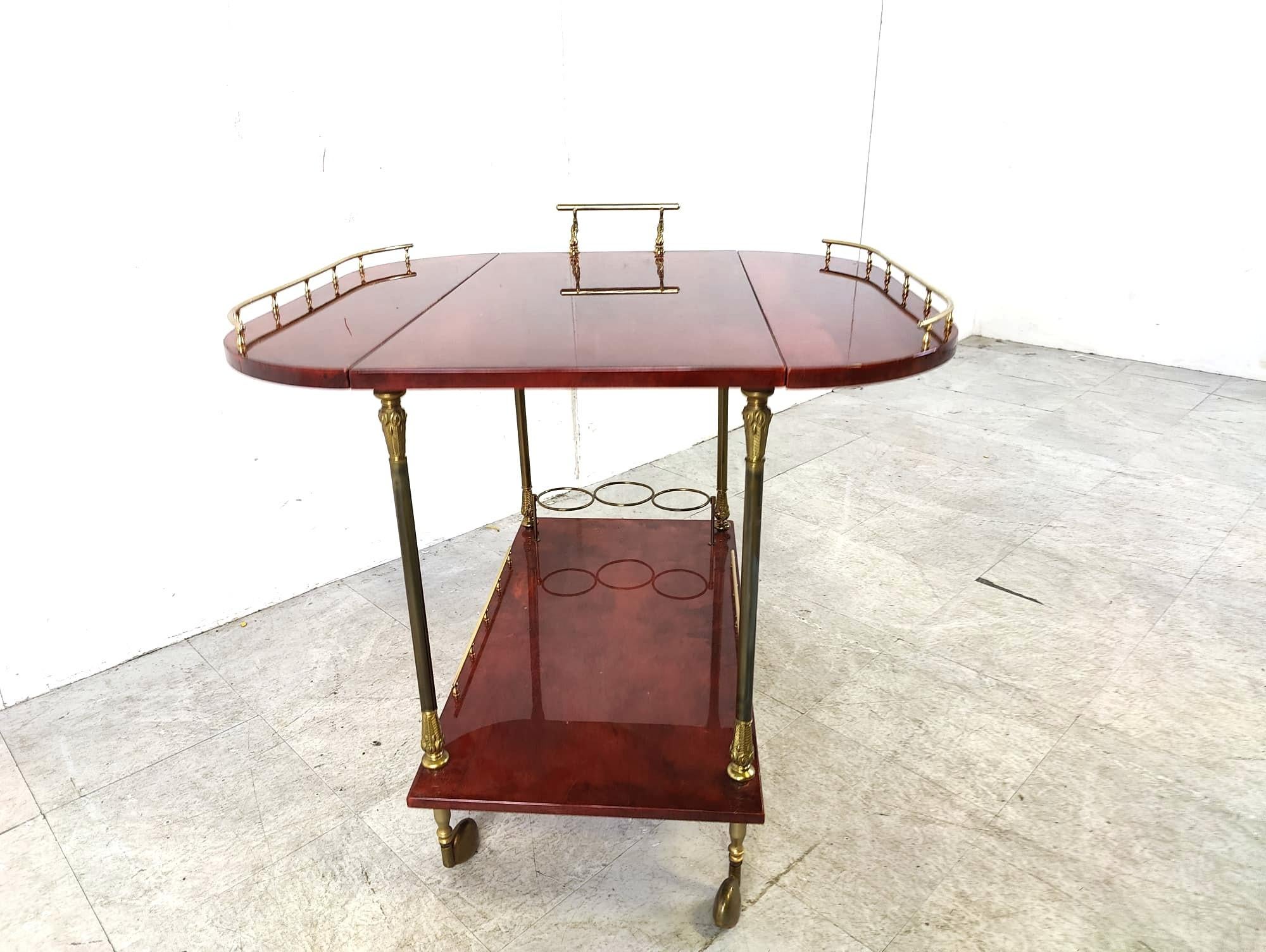 Very rare Aldo Tura Goatskin or parchment bar cart. This bar cart was made in Italy in the 1960s. 

Constructed of lacquered goatskin / parchment and gilt metal hardware.

The table tops can fold down to make the car narrower when needed.

Perfect