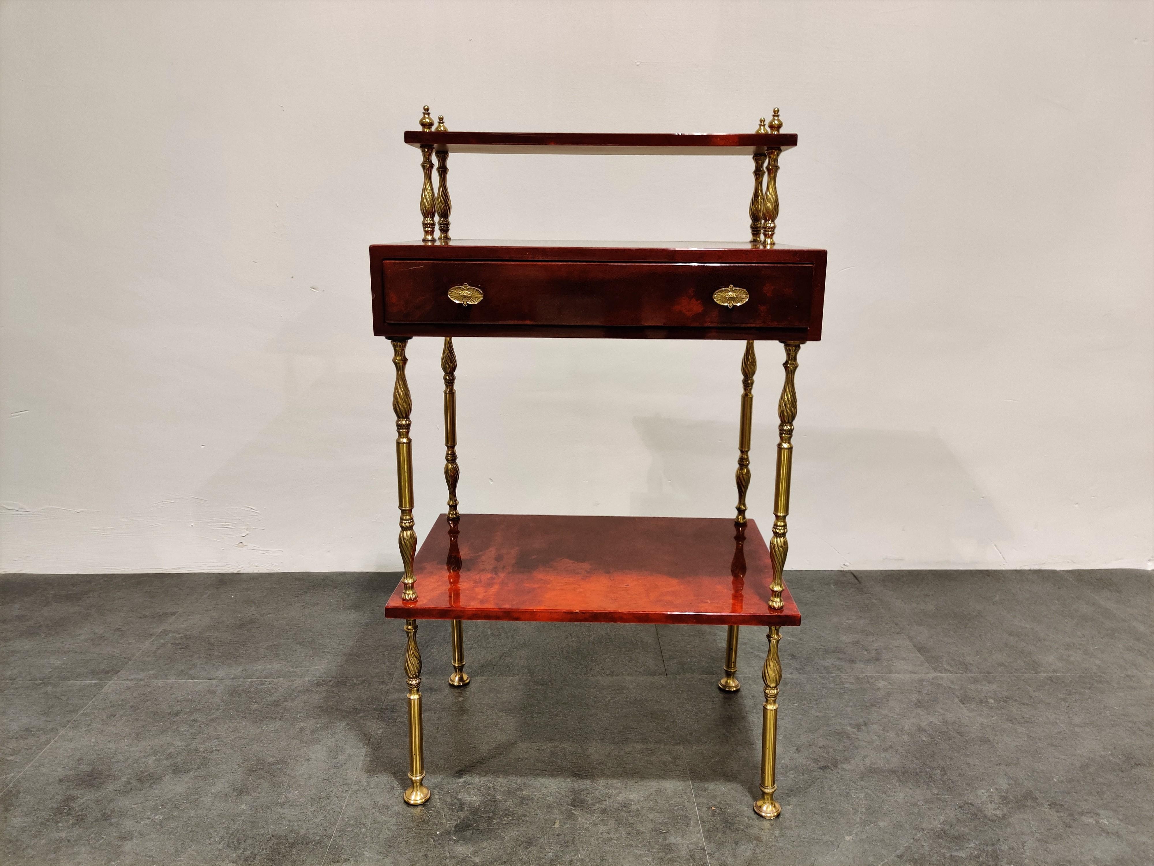 Very unique Aldo Tura red lacquered Goatskin or parchment side table. 

Constructed of thickly lacquered goatskin / parchment and gilt metal hardware. 

Comes with a doubled handle drawer.

Good condition.

1960s -