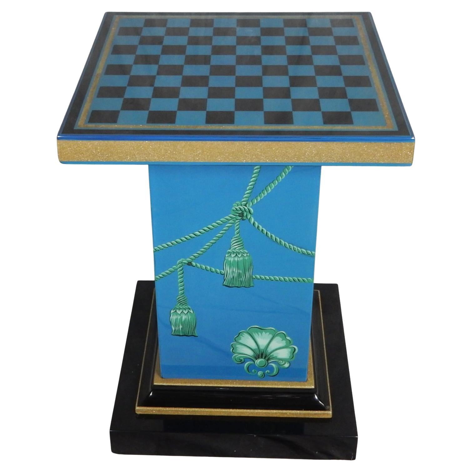 Stunning Italian lacquered lithographic print pedestal foyer table
in the manner of Piero Fornasetti. Not signed.
Checkered top banded in gold with rope and medallion on sides. 
High quality glossy lacquer finish.
Condition:
Light swirl