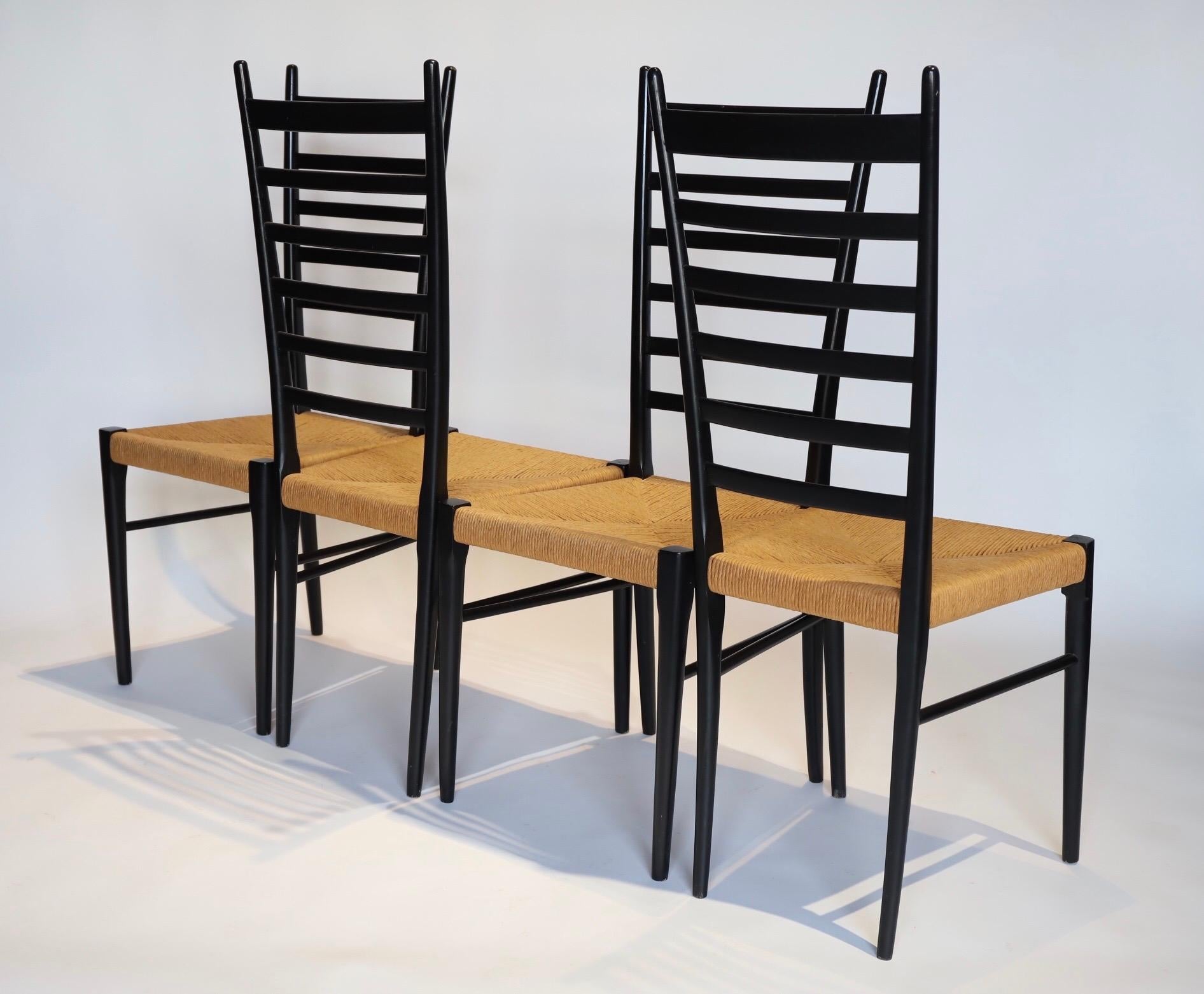 Stunning set of 4 black ladder back dining chairs with jute seats in the style of Gio Ponti, made in Italy. Photographed with Eames DCM for scale.