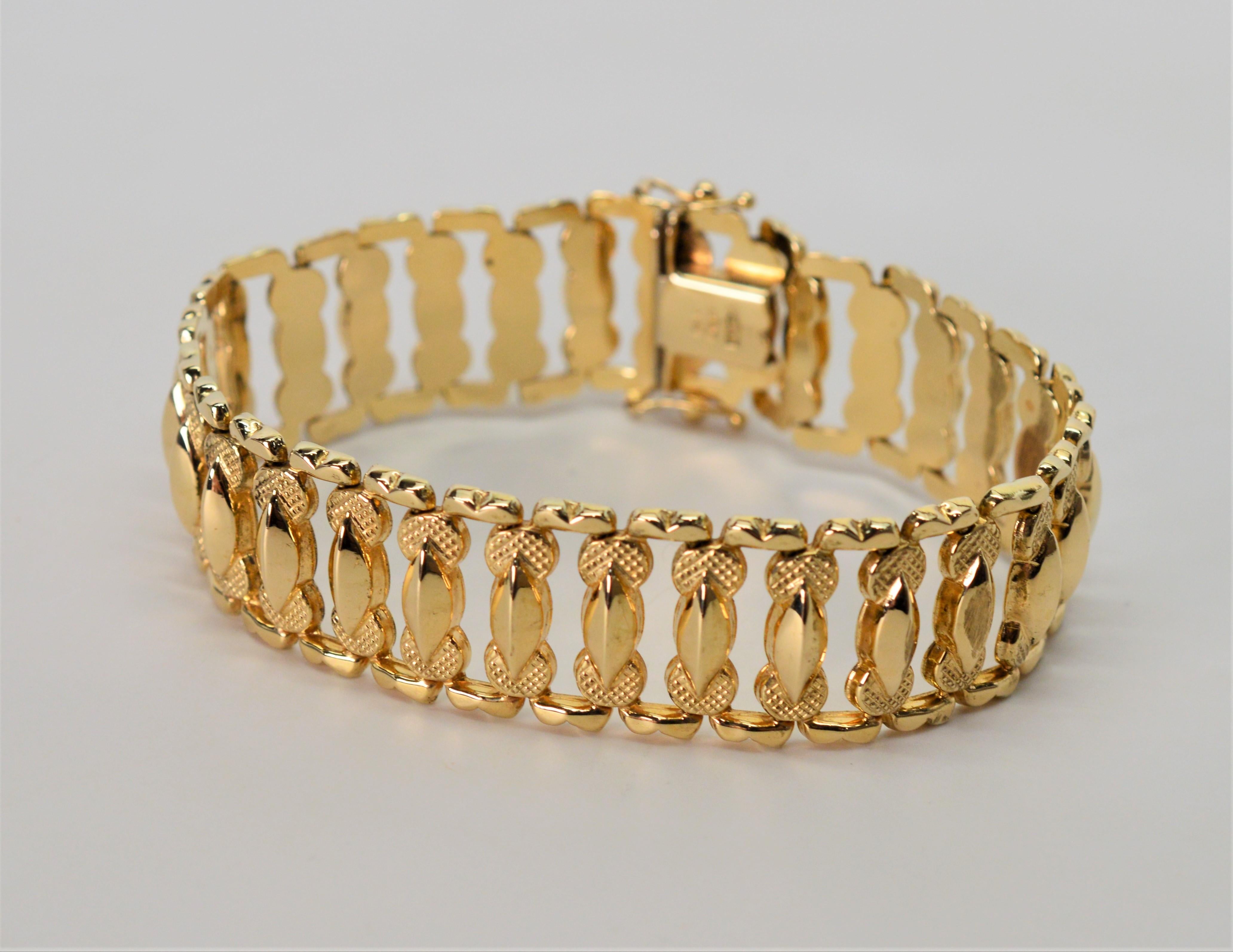 Quality Italian made bracelet perfect for any jewelry wardrobe. 1950's style ladder link bracelet in bright fourteen karat 14K yellow gold. 
Measures 7- 1/4 inch in length and 5/8 inch wide. Outfitted with box clasp and two safety clips. Stamped and