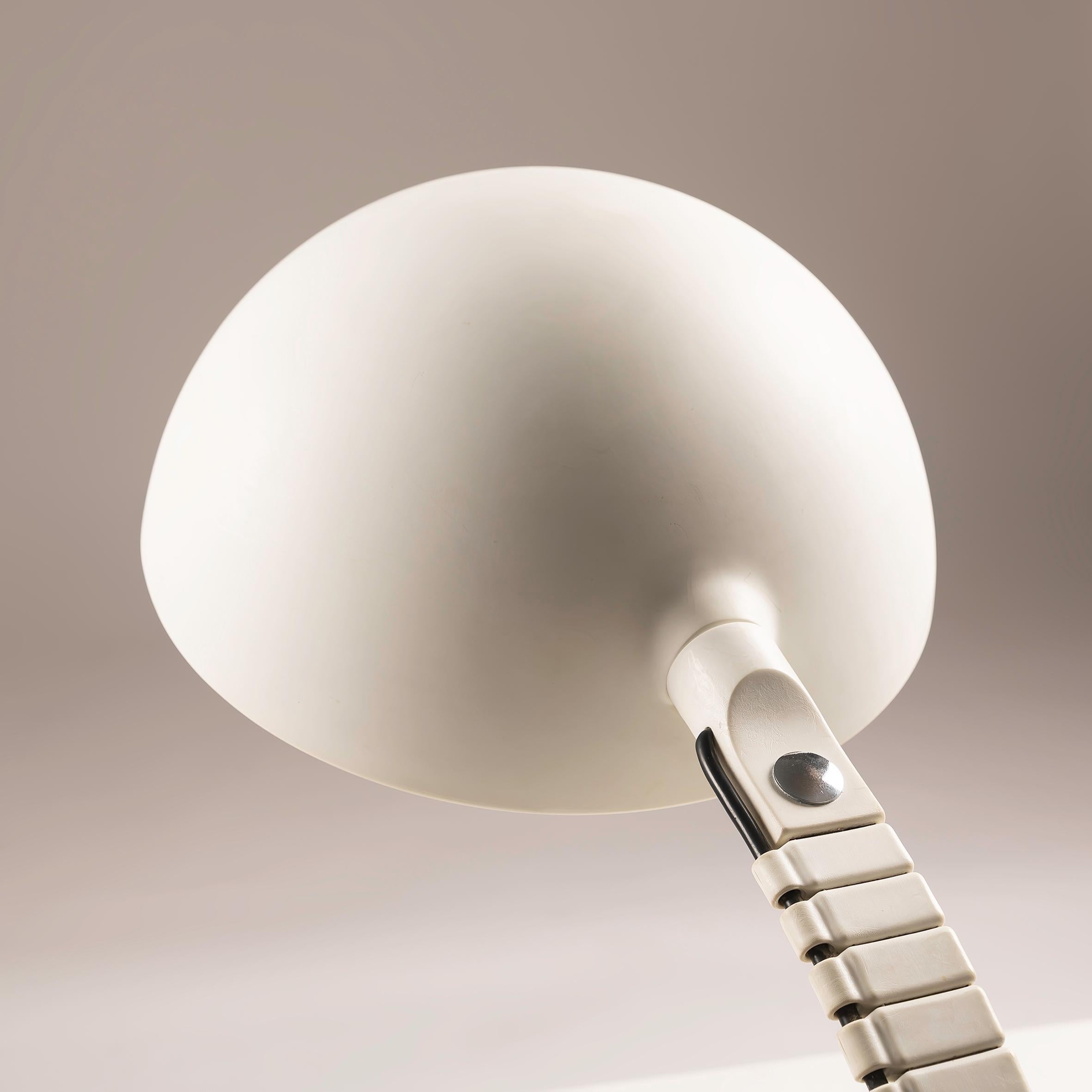 This Italian Lamp by Elio Martinelli for Martinelli Luce, No 660, crafted in Italy during the 1970s, is a must-have for any discerning collector or enthusiast of mid-century modern design. Elio Martinelli's innovative approach to lighting design is