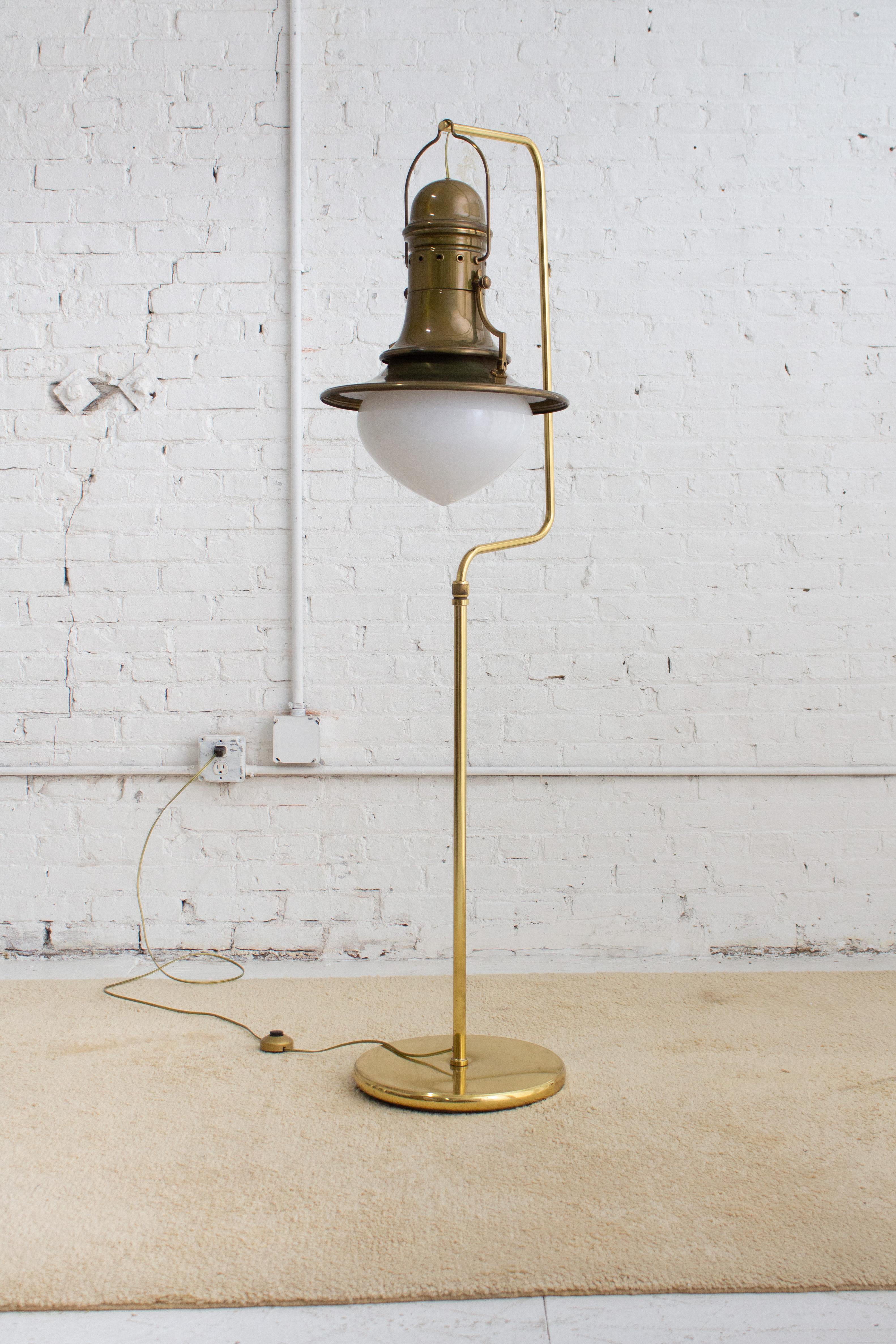 An Italian lantern style floor lamp. A brass stand with heavily weighted base holds an 
