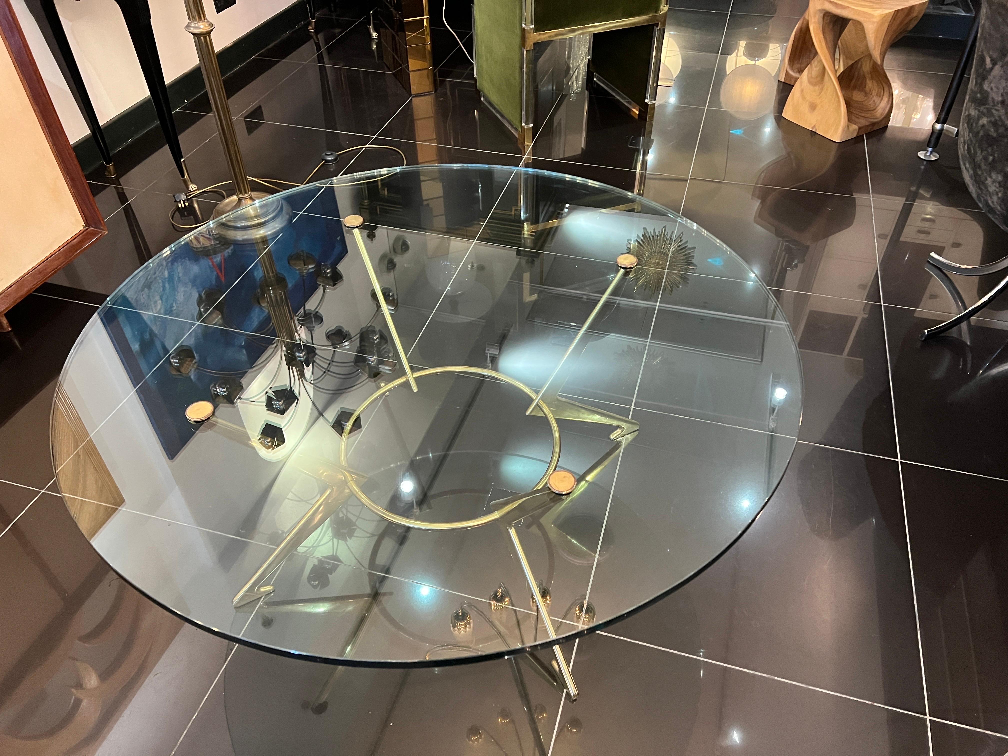 An extraordinary large circular coffee table consisting of 20mm thick round glass top 120cm (47.5 inches) in diameter supported by architecturally designed solid brass base with brass upper bolts . A truly magnificent centre piece designed and