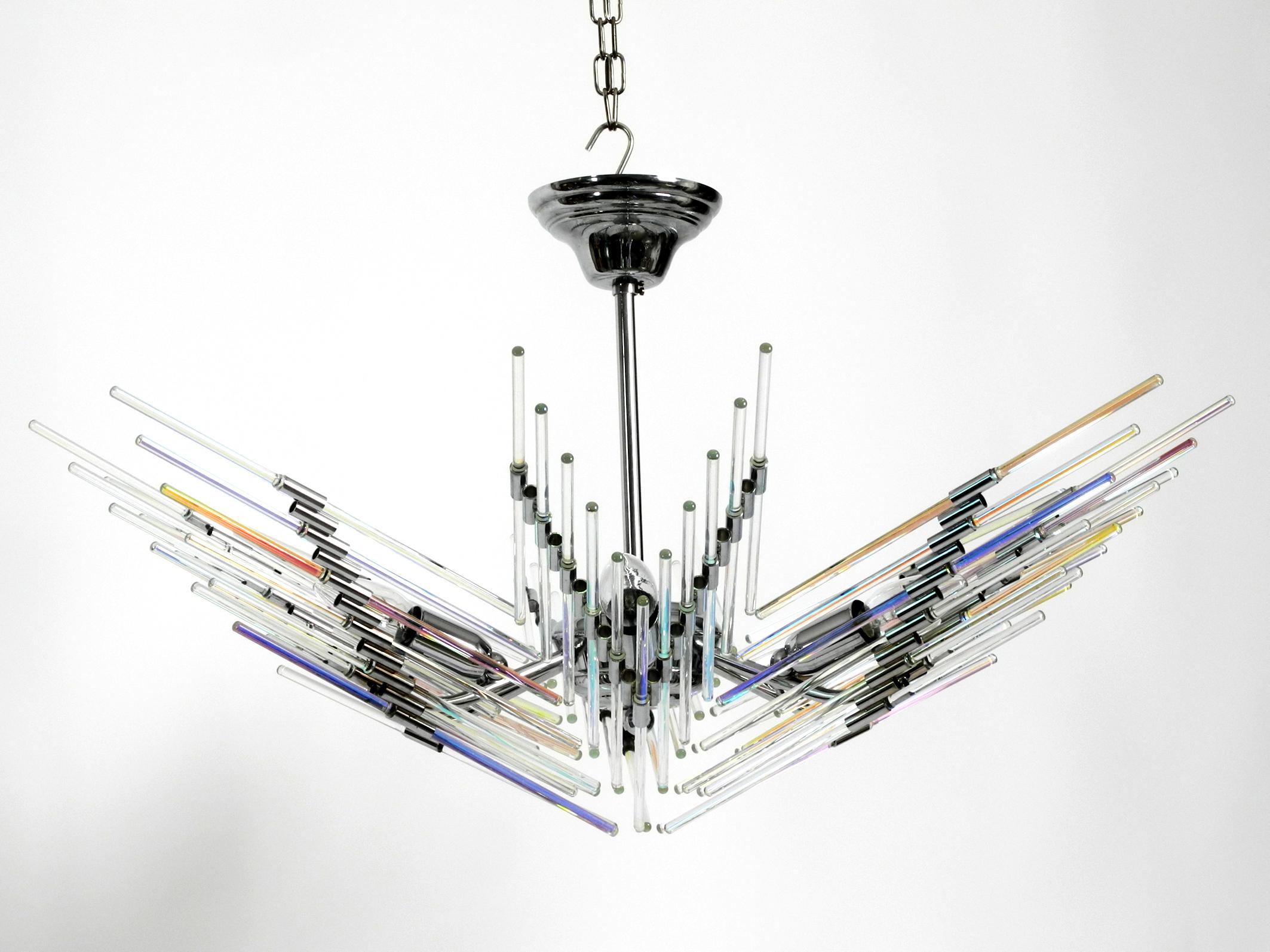 Beautiful extraordinary and large chrome ceiling lamp with long glass rods. 
The transparent glass rods shine in different colors when the light is switched on. 
Made in Italy in the 1980s.
The complete frame is made of chrome metal.
The glass