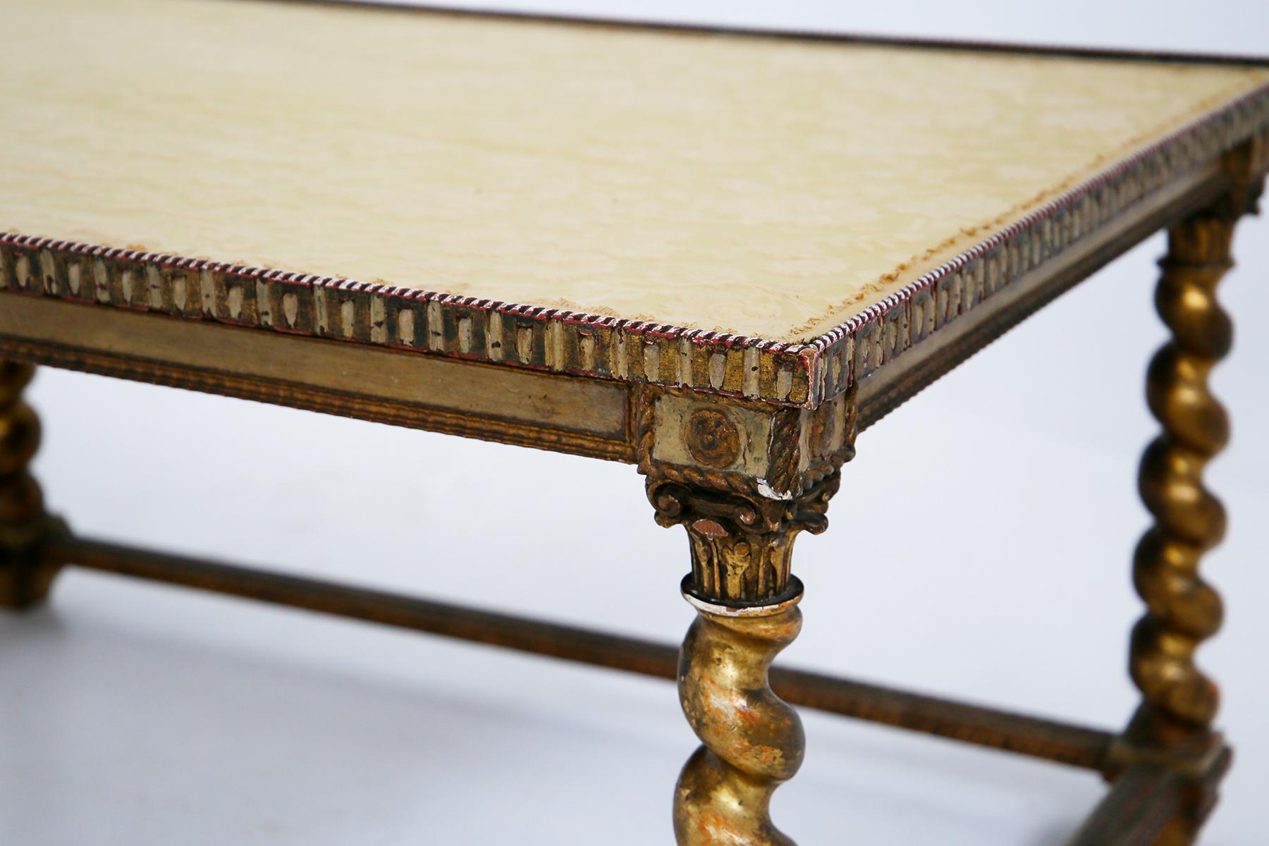 Large neoclassical Italian coffee table from the end of the 19th-beginning of the 20th century. The coffee table is made of gilded wood. The four legs are torchon shaped with carved wooden tips. Skillful workmanship also for the circumference of the