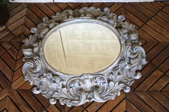 Italian Large Deeply Carved Wooden Oval Mirror With Beveled Glass, Circa 1980s