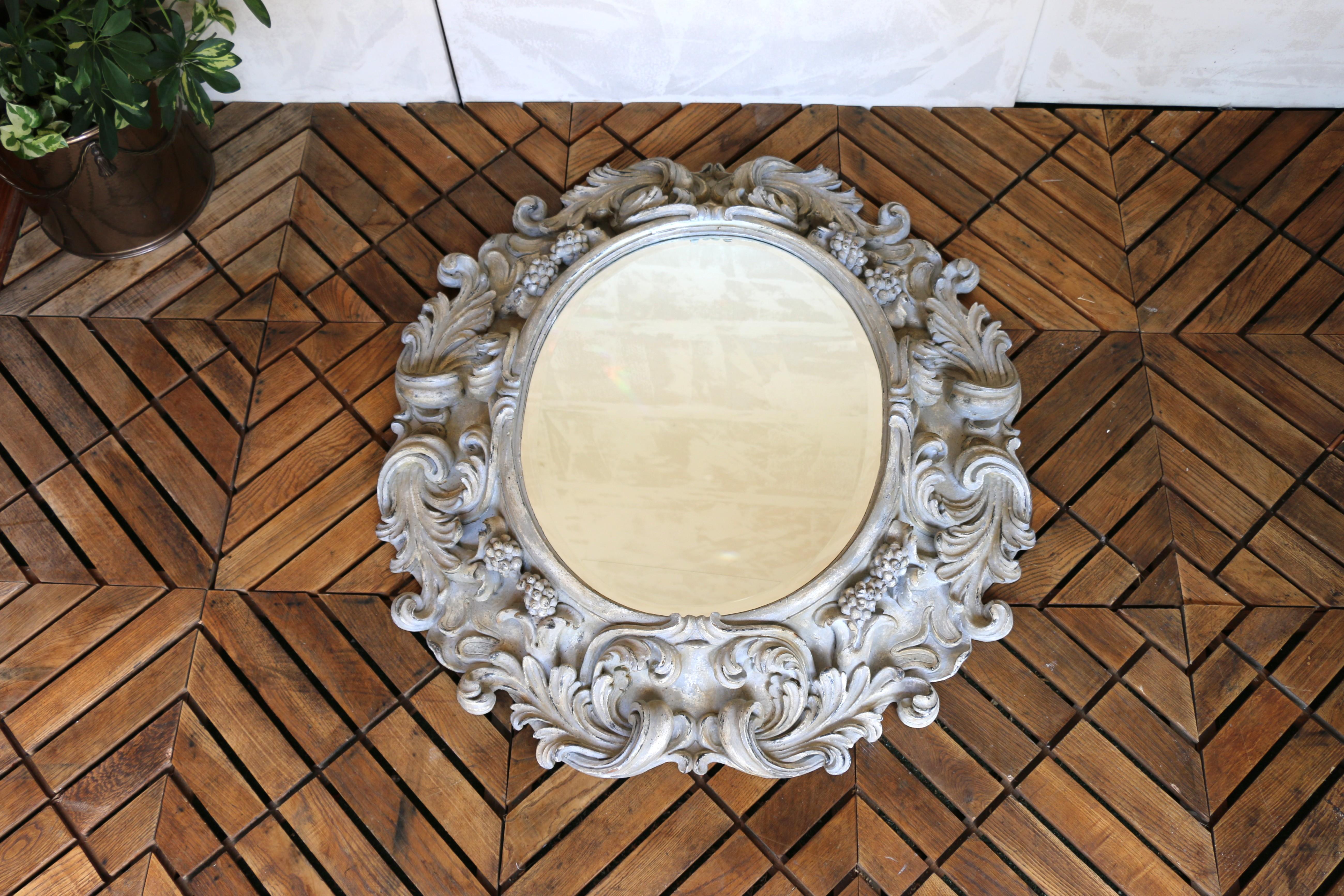 Country Italian Large Deeply Carved Wooden Oval Mirror With Beveled Glass, Circa 1980s For Sale