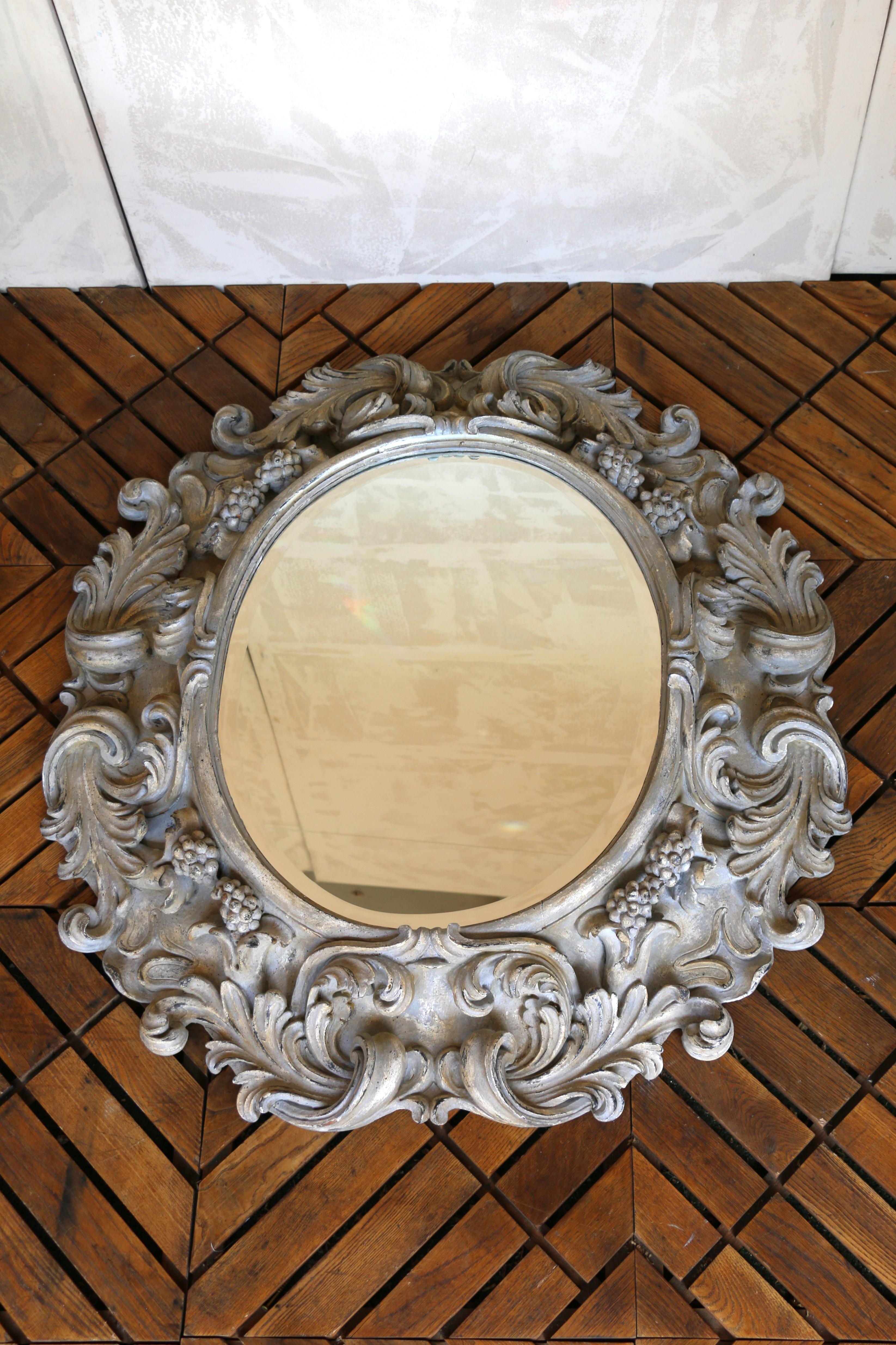 Italian Large Deeply Carved Wooden Oval Mirror With Beveled Glass, Circa 1980s In Good Condition For Sale In North Hollywood, CA