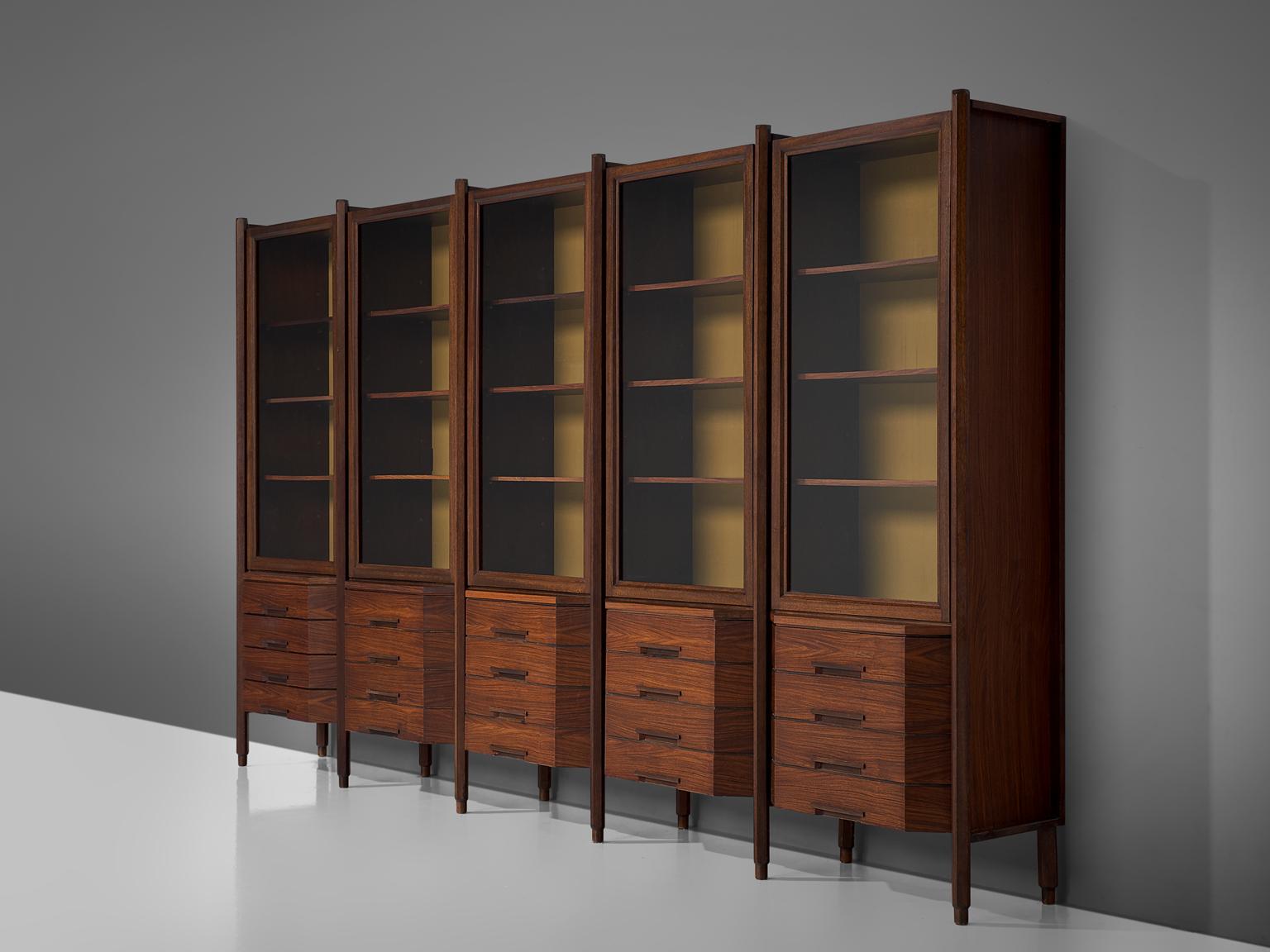 Large cabinet, rosewood and glass, Italy, 1960s.

Stunning Italian wall unit consisting of 5 compartments. Every compartment of this rosewood bibliotheque is built up out of several shelves, accessible through a glass door. Below you'll find 4