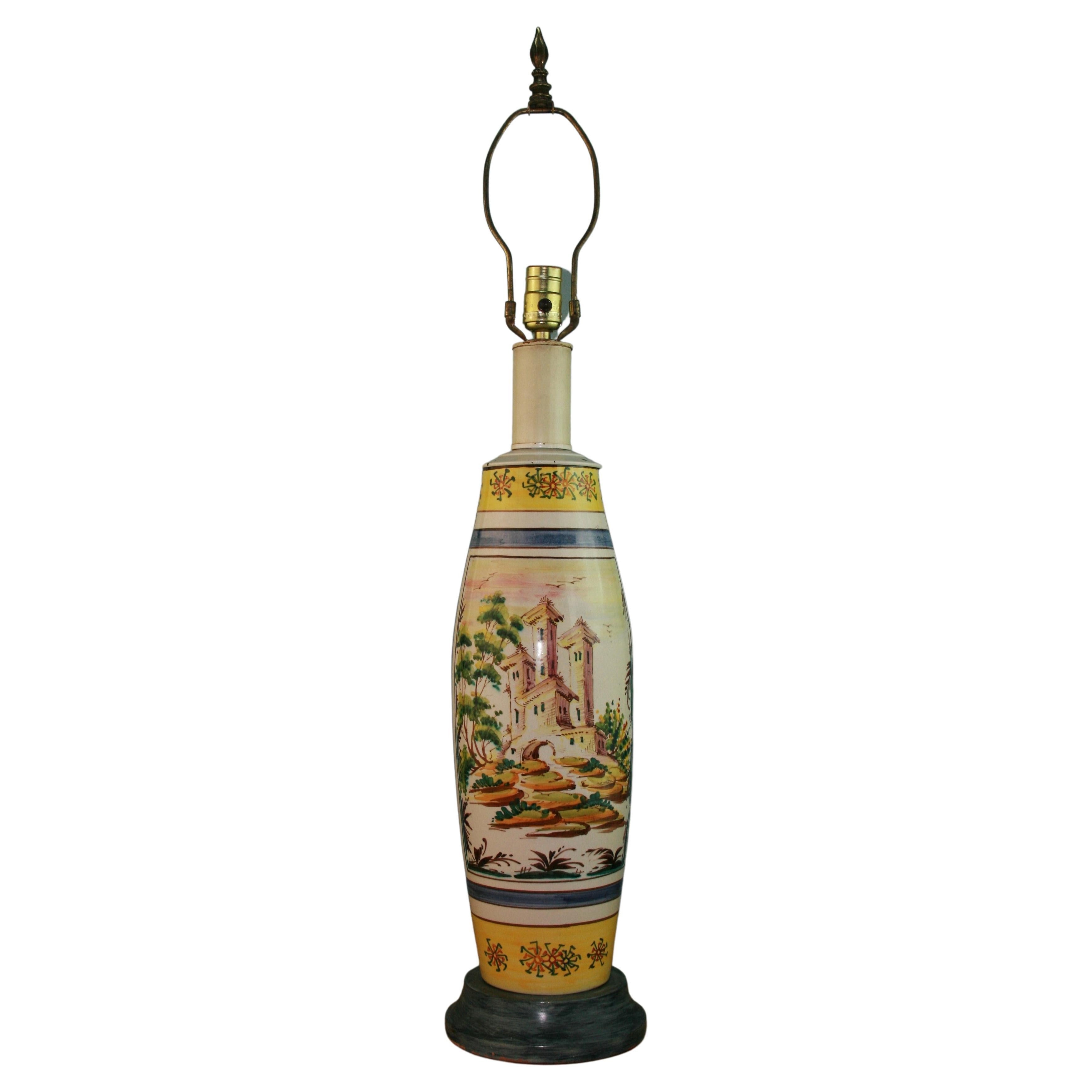 3-953 Italian hand painted 2 sided ceramic lamp on wood base.
One side with figurative painting the other a village scene
Measures: height to top of socket 26