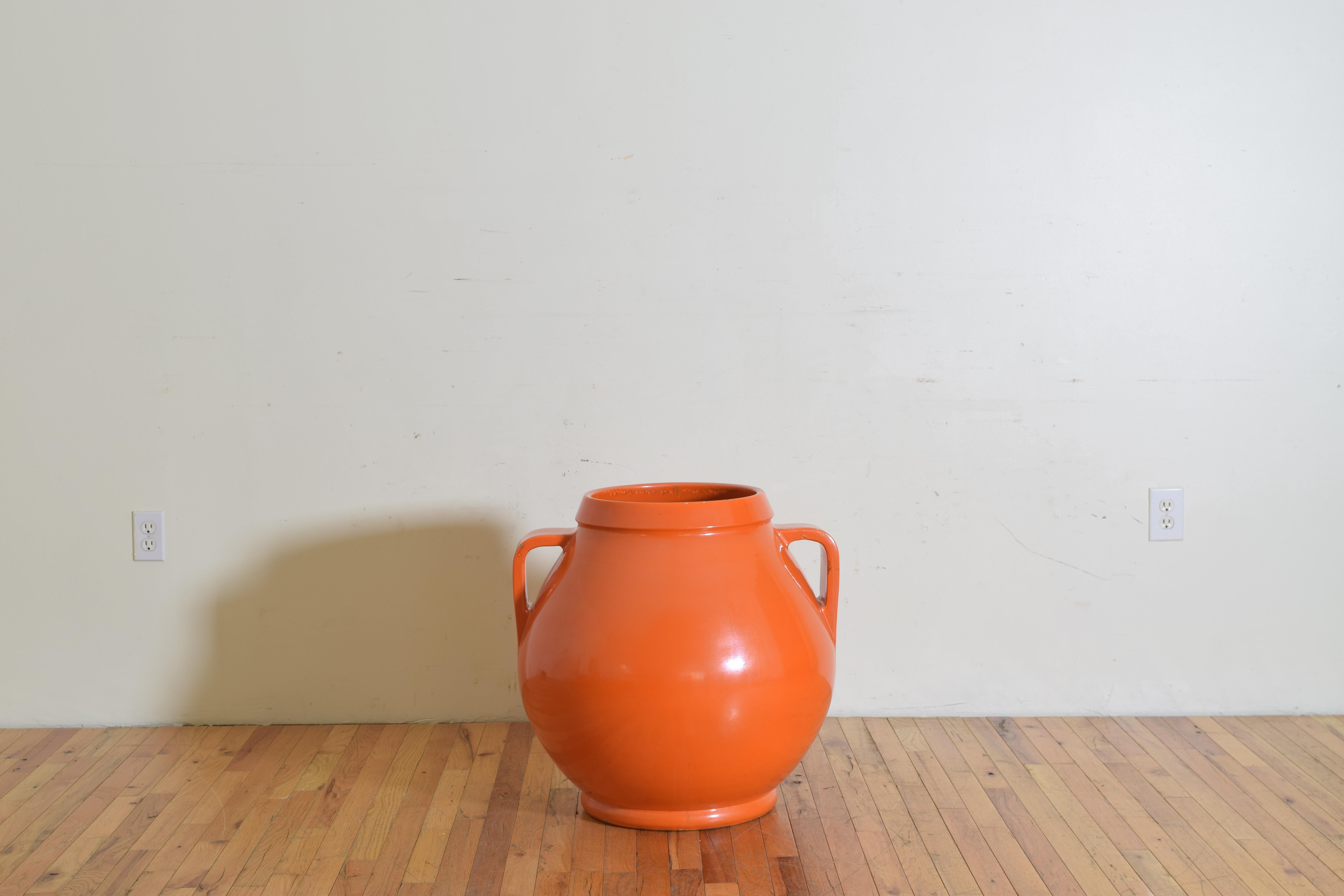 Large orange planter / urn with handles. Shows signs of age and small chips in the lacquer.