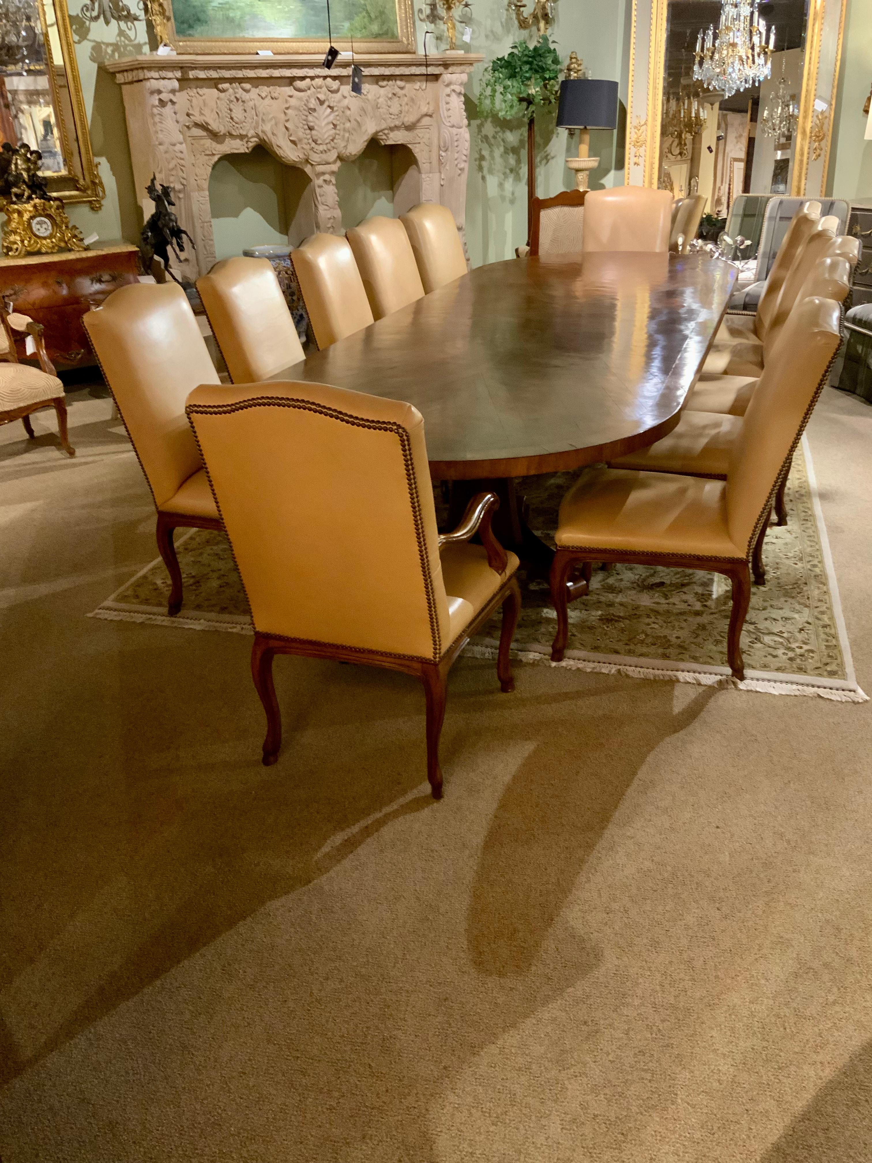 This set is made of a warm walnut and is long enough to seat 12 
Comfortably. It has two triangular shaped pedestals. It is banded in
A lighter hue and the patina us original in a medium sheen. It is
Finished well ! The 12 chairs have custom