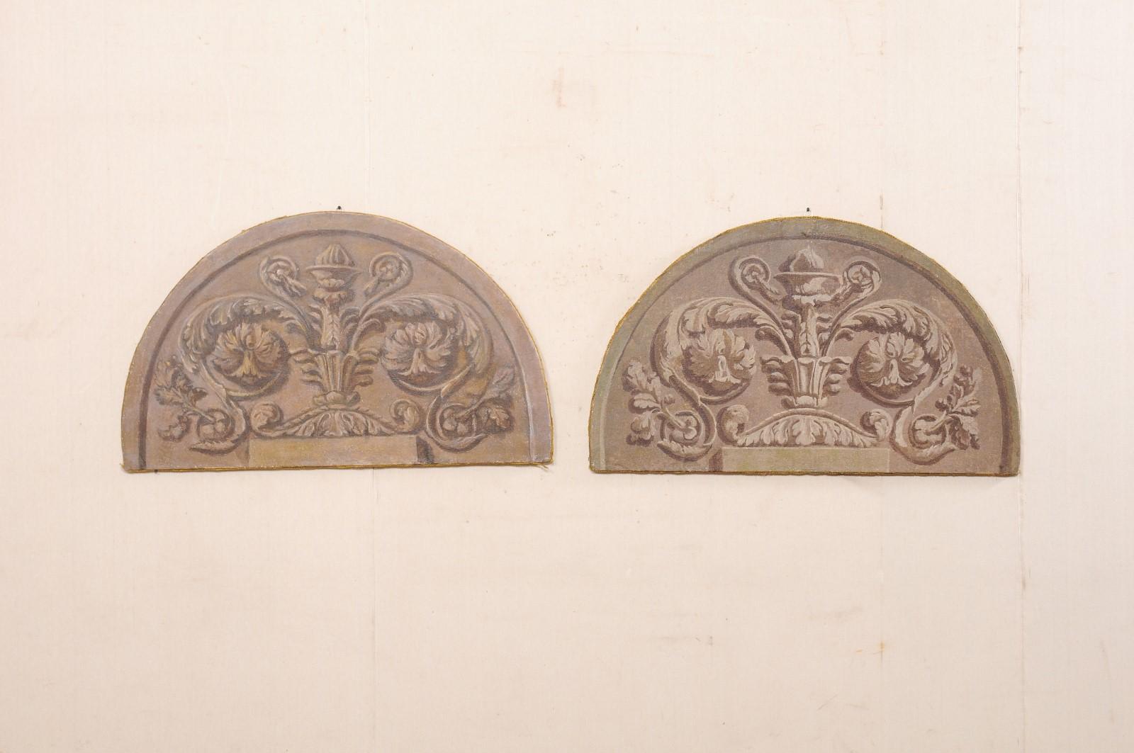 An Italian pair of stretched canvas paintings from the 19th century. These antique wall decorations from Italy each have painted canvas stretched over an arch-shaped wood frame, nearly 4 feet in width. The paintings are Neoclassical in design