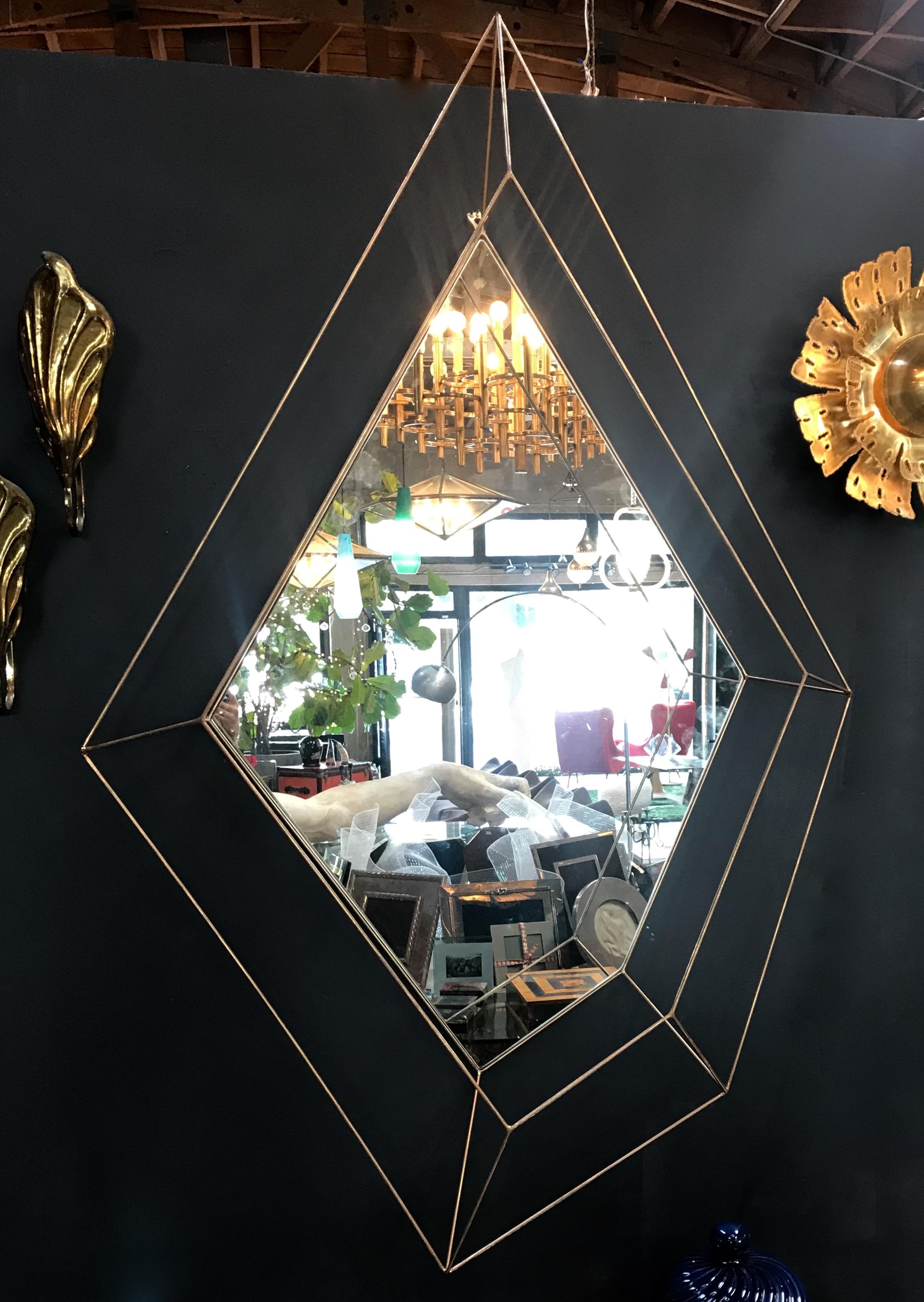 Italian large Rhomboidal sculptural wall mirror in brass.
This mirror can also be mounted horizontally.