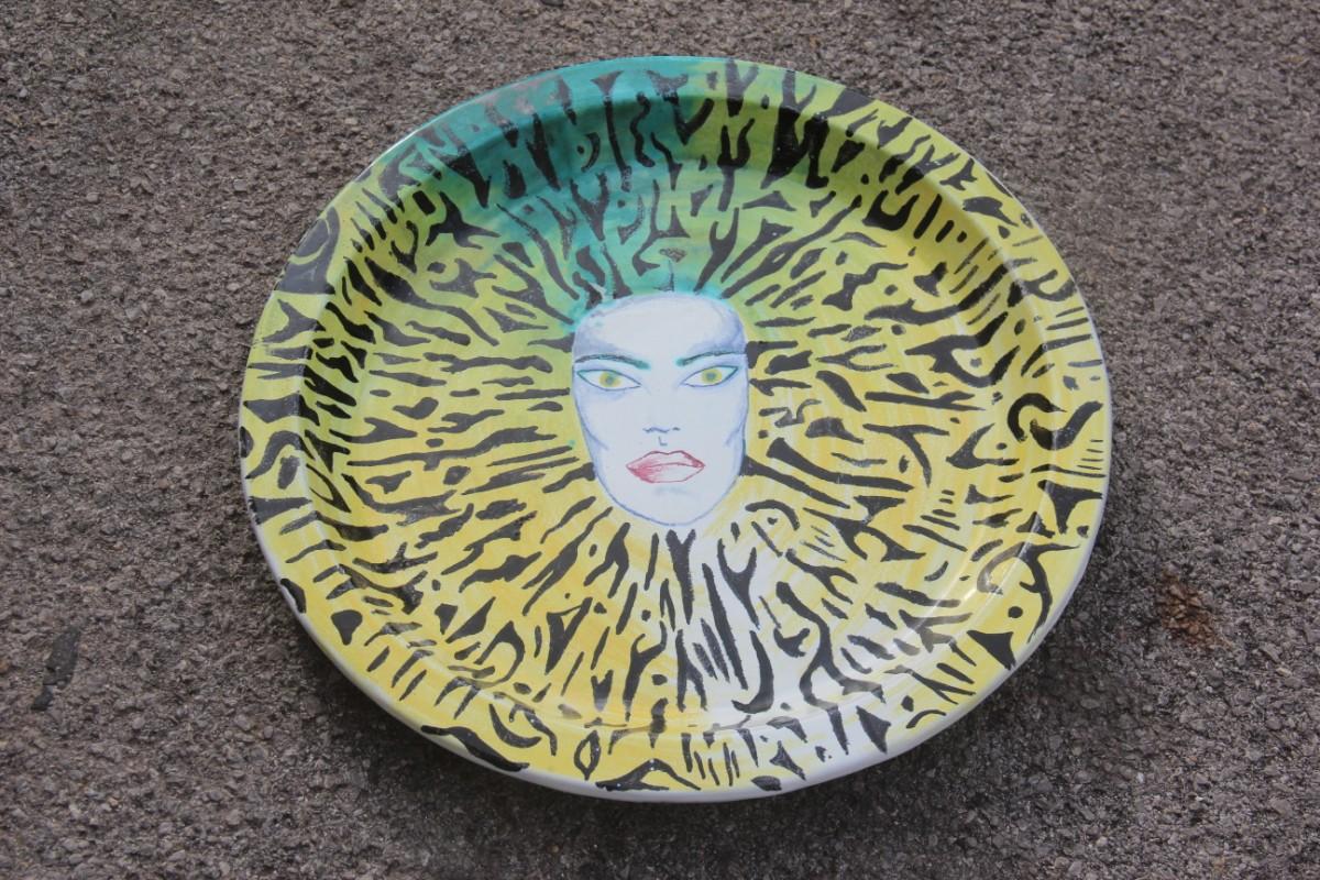 Italian large round ceramic dish plate from the 1980s. Multicolored face yellow green.
