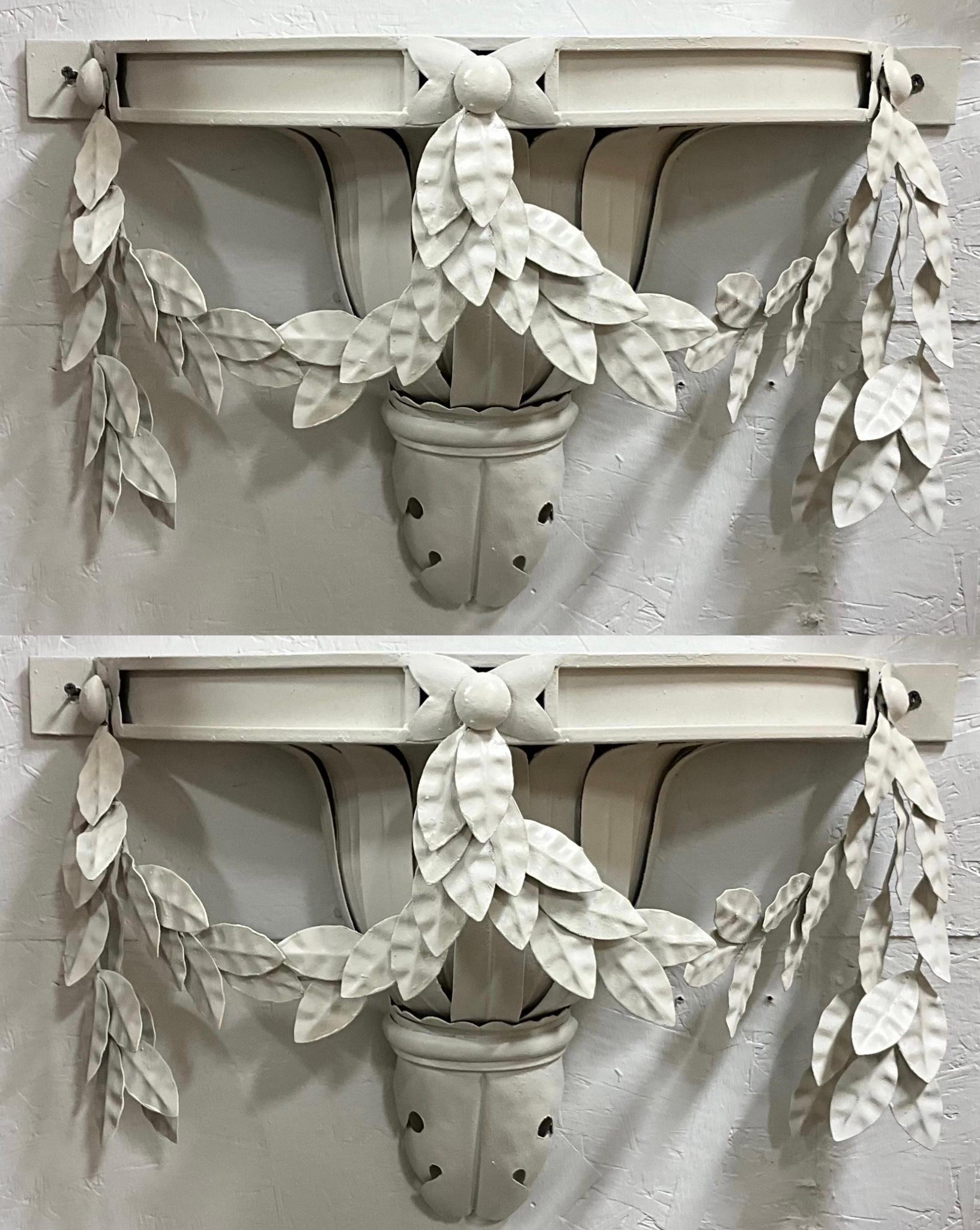 This is a pair of large scale Italian neoclassical style tole wall sconces. They are white, which appears to be original. They have draping Greco-Roman foliate. They are in very good vintage condition.
