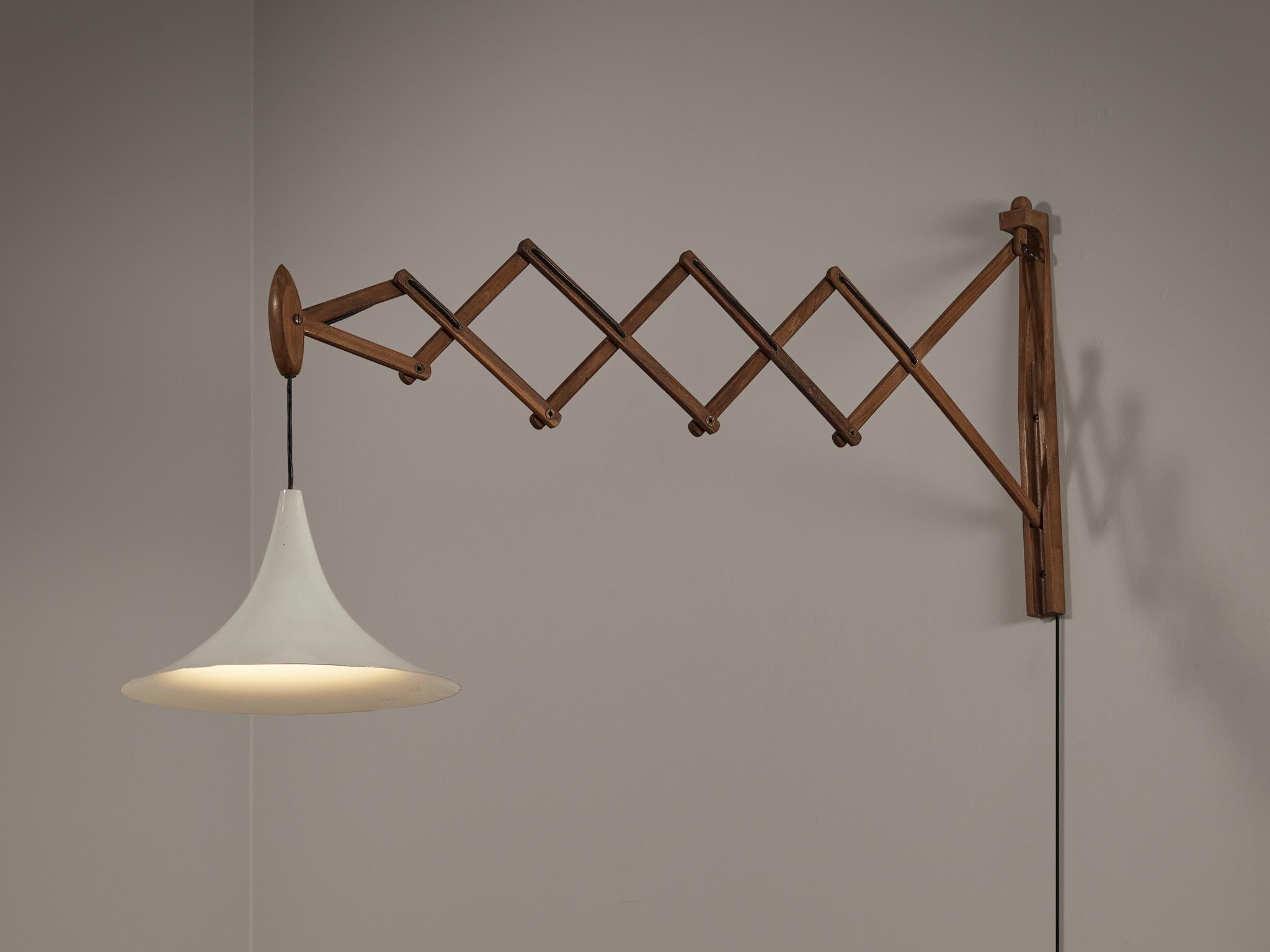 Scissor wall light, teak, coated aluminum, brass, Italy, 1950s.

This Italian scissor wall light is of considerable size and designed with practicality in mind. The scissor feature enables the user to move the flexible arm as an accordion, pushing