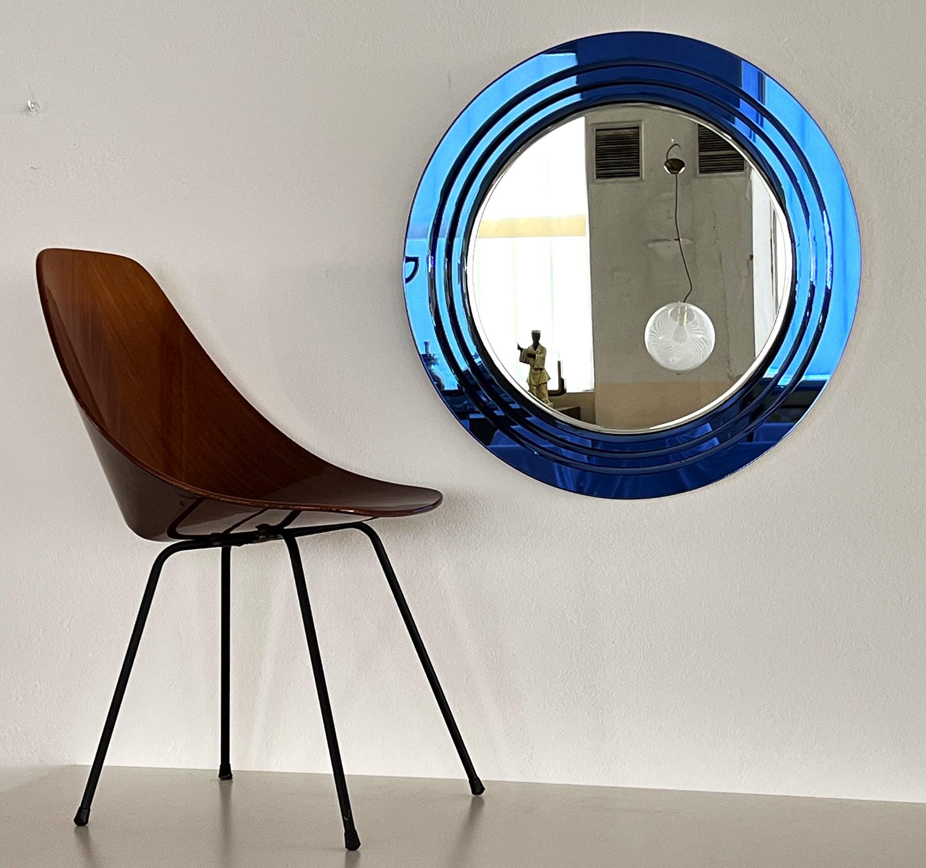 Magnificent large wall mirror made of 3 layers of cut glass in shiny blue color.
Made in Italy in 1971.
The glasses are in very good condition with very few and smallest spots under the blue glass.
The original crystal mirror glass in the middle is