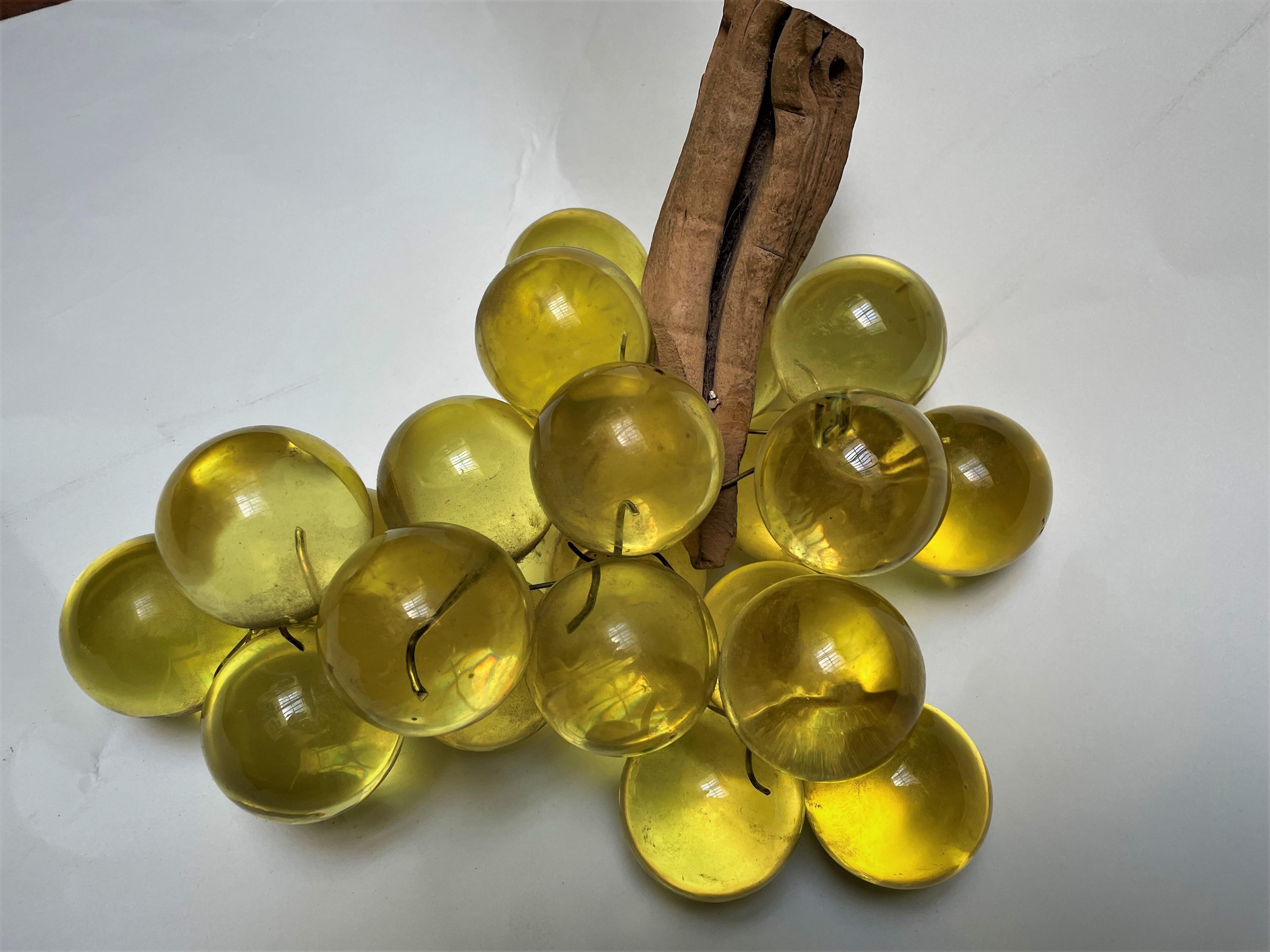 You want a splash of color? Here it is! These glassy yellow grapes are huge, about 2 inches in diameter each and they are full of pale yellow light reflecting color! The Lucite grapes are held to the rustic driftwood with wire and are flexible so
