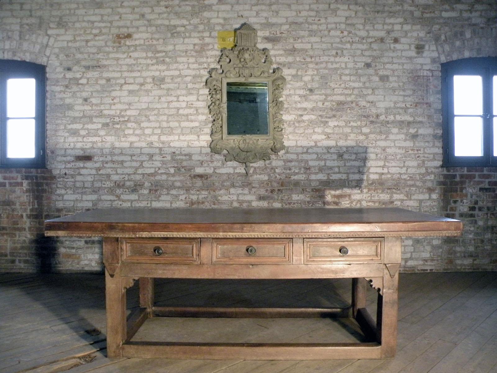 Extraordinary, large Italian Renaissance table of strong, linear design. The thick 2-plank top with a narrow dentil edge, above a frieze containing three drawers, supported by massive square legs joined by conforming, low box-stretchers. The strong