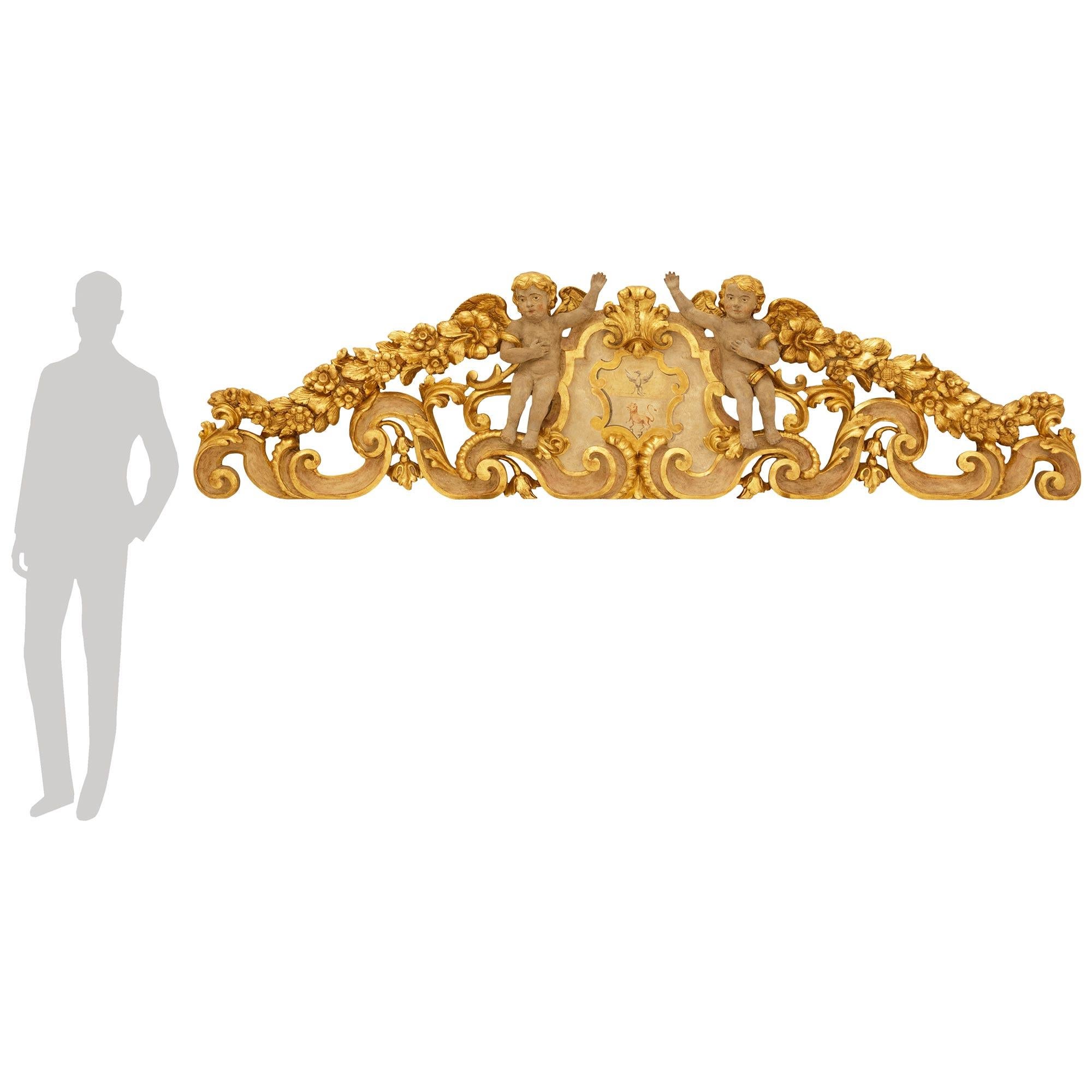 A monumentally scaled and most decorative Italian late 17th century Baroque Period Venetian st. patinated Wood and Giltwood wall decor. This most impressive wall decor/plaque is underlined by opulently sculpted patinated Wood scrolled foliate base