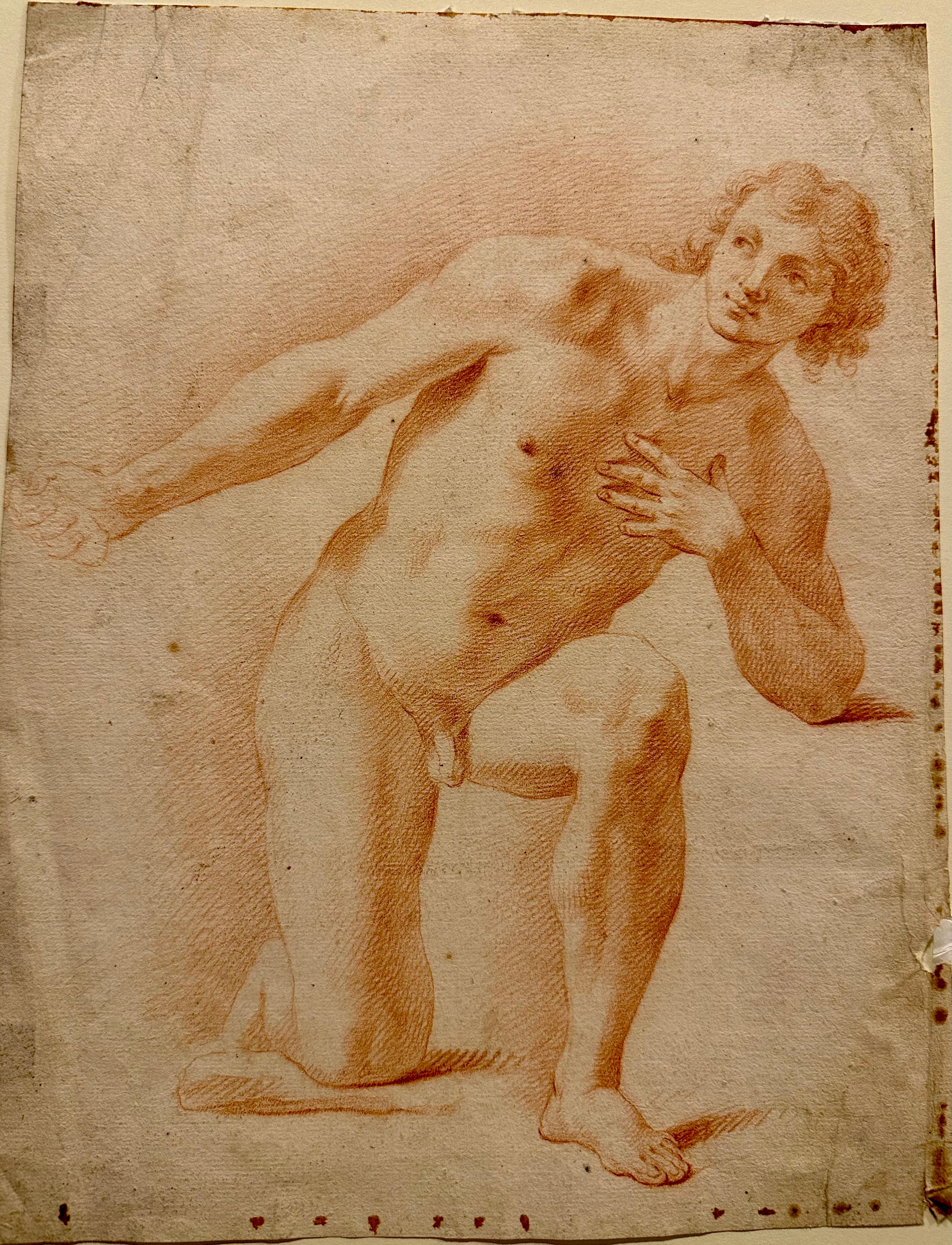 Italian Bolognese Late 17th Century Red Chalk (Sanguine) Drawing of a Kneeling Young Man. Circa 1680

This Sanguine drawing is in good condition. Small dark brown spots are visible around the edges of the sheet.

This drawing from the end of the