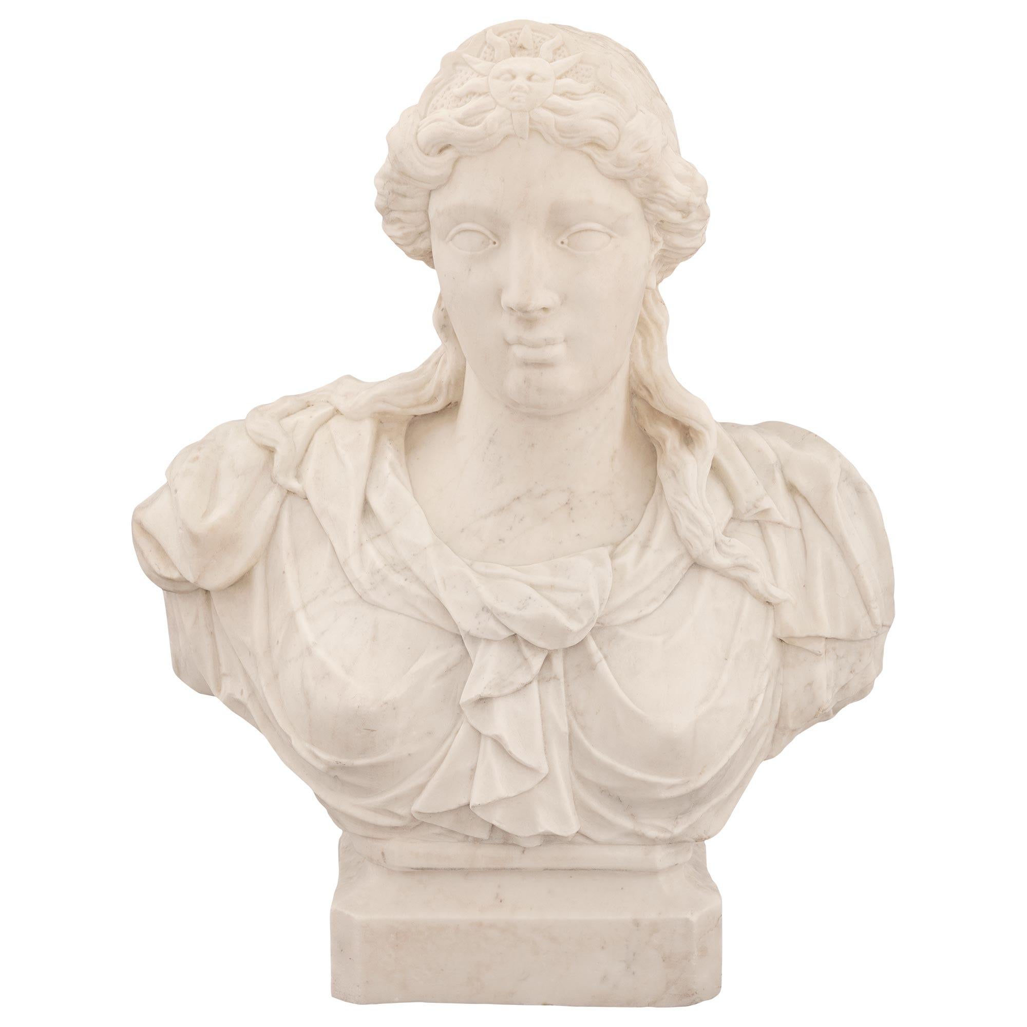 An impressive and very high quality Italian late 17th / early 18th century white Carrara marble bust of Athena. The bust is raised by a rectangular base with cut corners and a fine wrap around mottled border. Above is the beautiful richly sculpted
