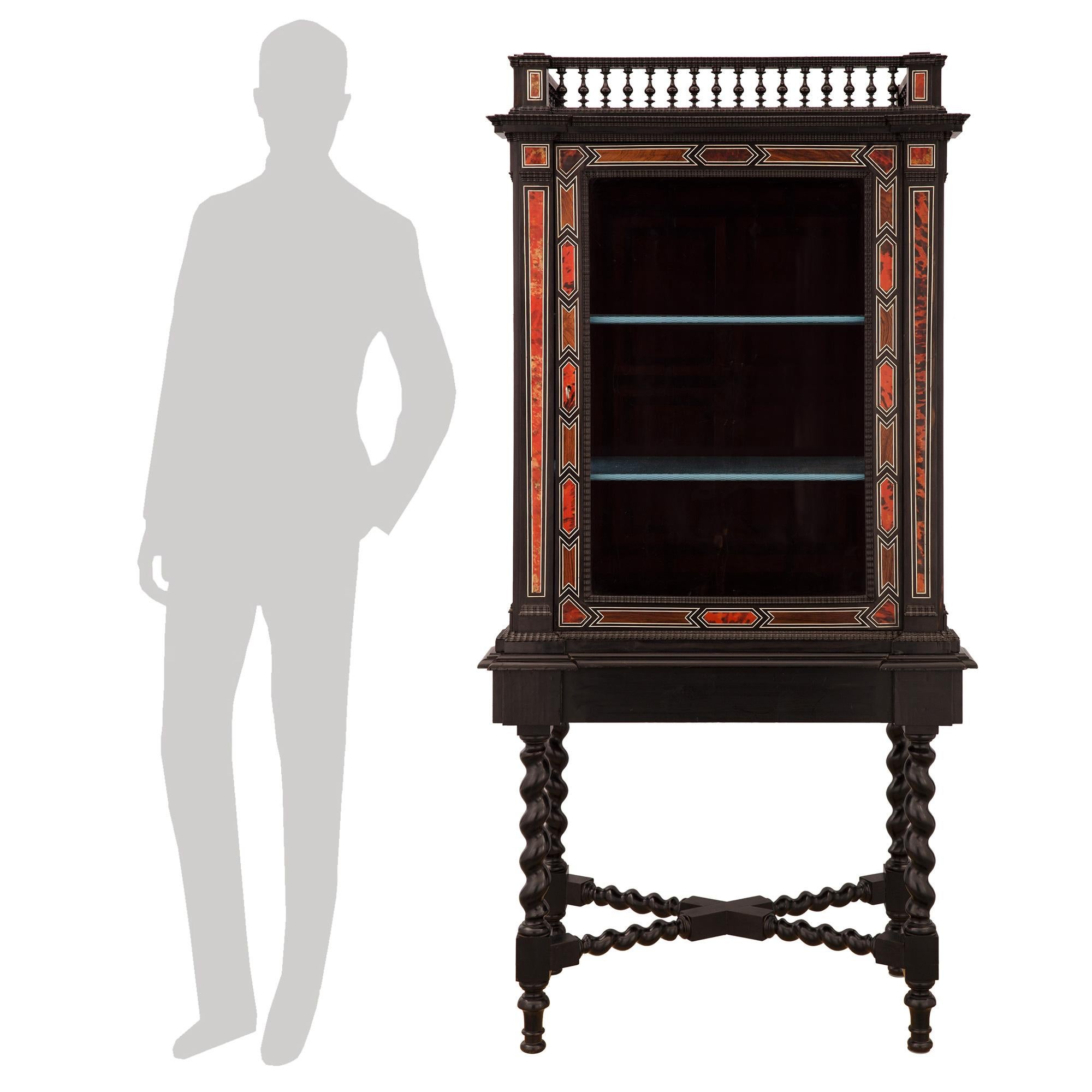 An impressive and most decorative Italian late 18th century Baroque st. ebony, rosewood, tortoiseshell, and bone cabinet vitrine. The vitrine is raised by elegant turned feet below block reserves and striking most decorative spiraled legs, each