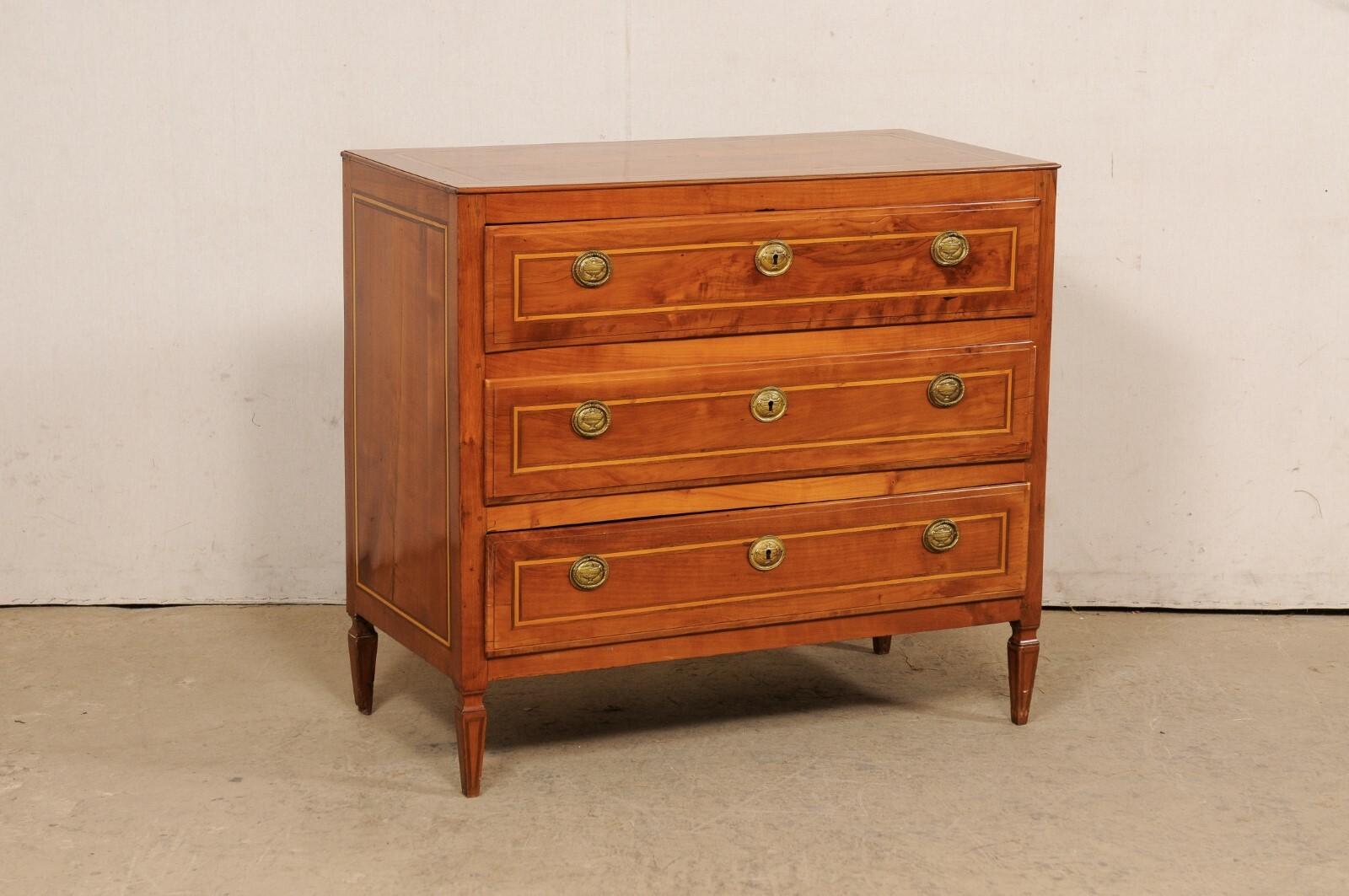 An Italian chest of drawers from the turn of the 18th and 19th century. This antique chest from Italy has been designed in clean/linear lines, and houses three full-sized and graduated drawers, each nicely outlined with a contrast banding inlay and