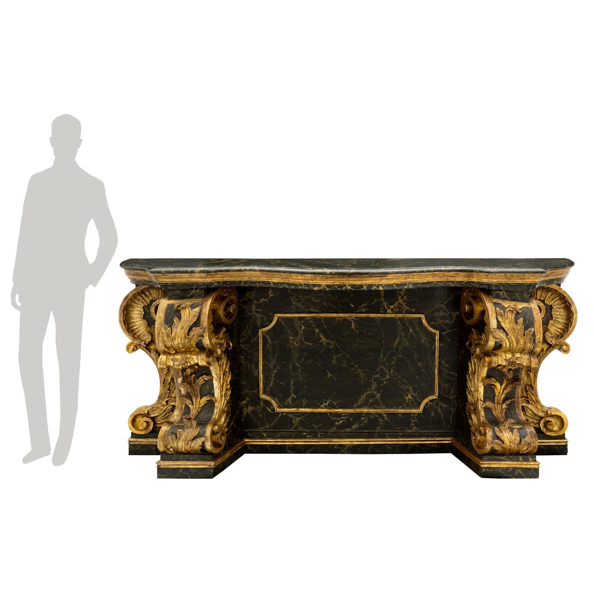 An impressive and monumentally scaled Italian late 18th/early 19th century faux painted Vert Doral marble and mecca console, from Sicily. The freestanding console is raised by a fine mottled band below stunning scrolled supports adorned with