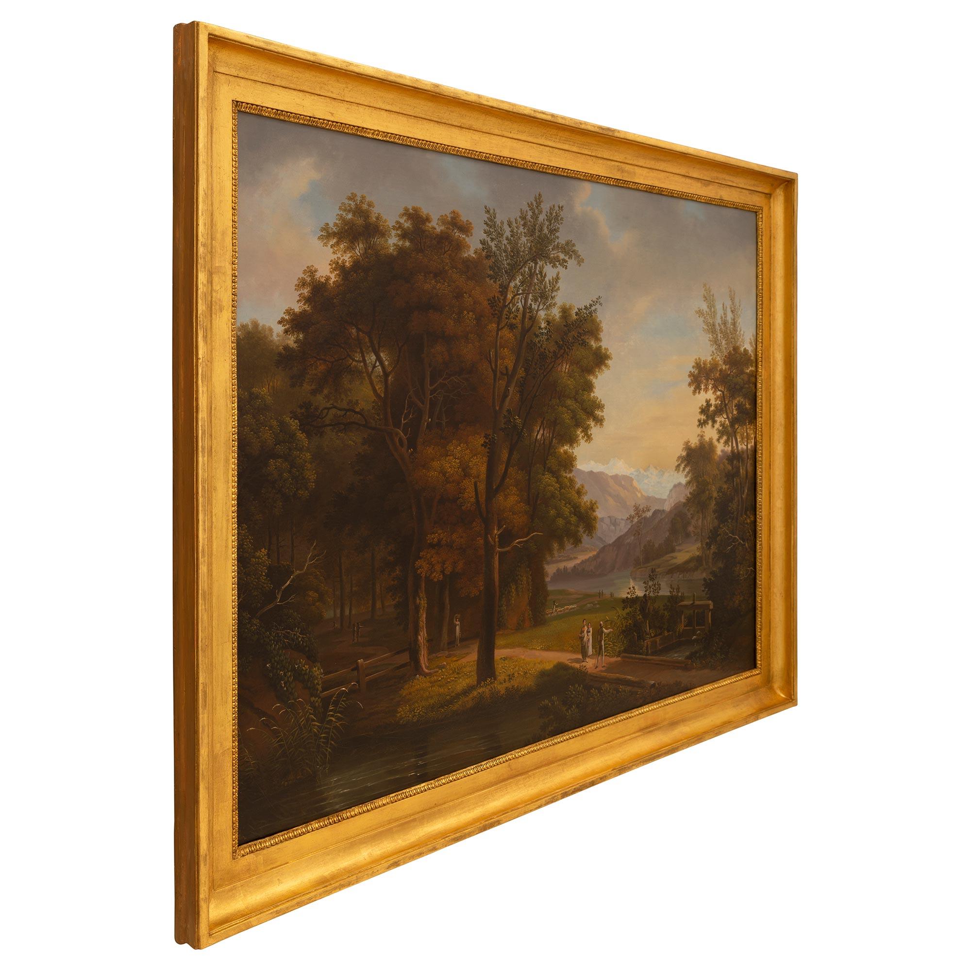 A stunning Italian late 18th century oil on canvas landscape painting. The painting depicts the beautiful Italian countryside with a charming path running through the center and water running under a bridge. In the background are a woman with a