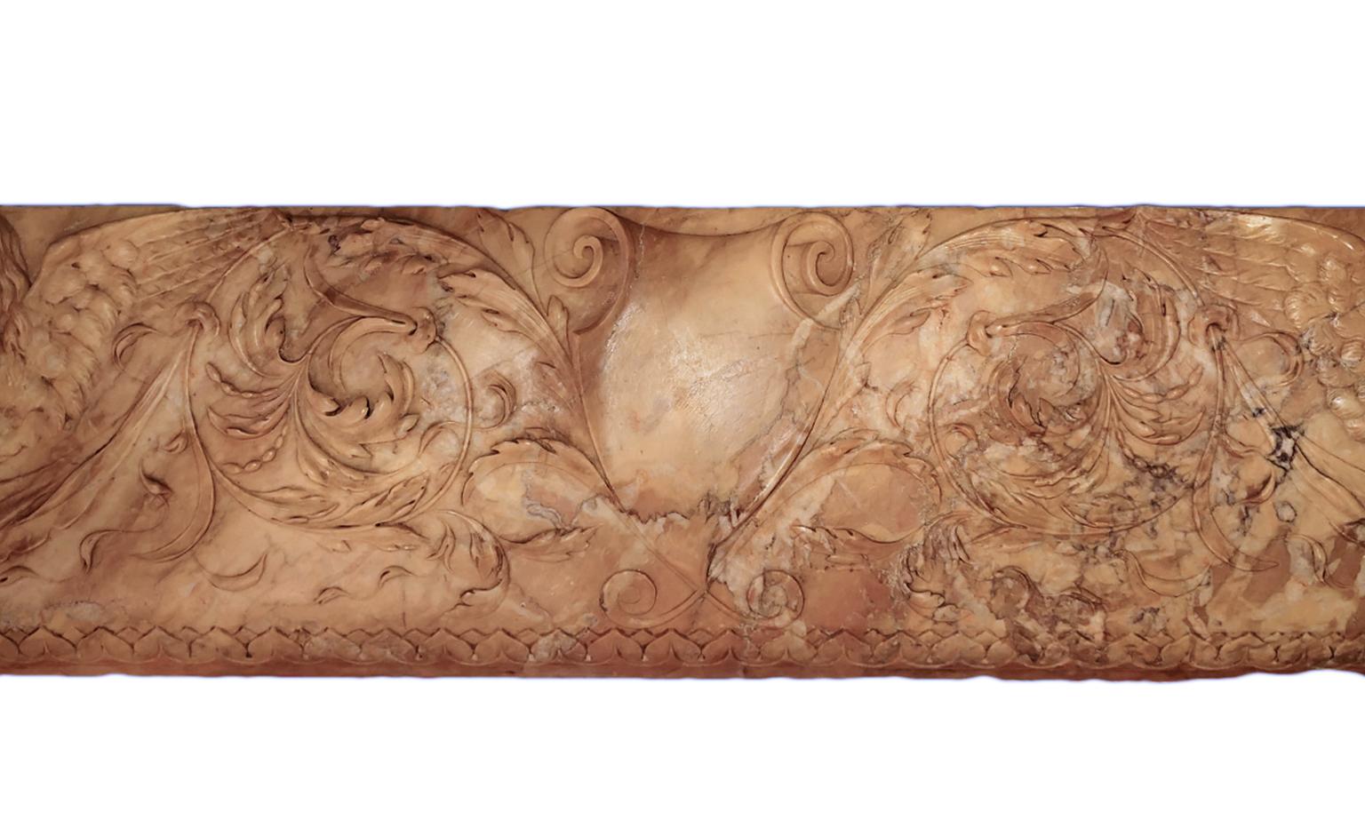 This well carved piece of Sienna marble has probably been used as support for a fireplace mantel. Now it has been mounted on a sturdy wood frame for instalment on a wall, above a door or similar for decoration. The carvings are very detailed and