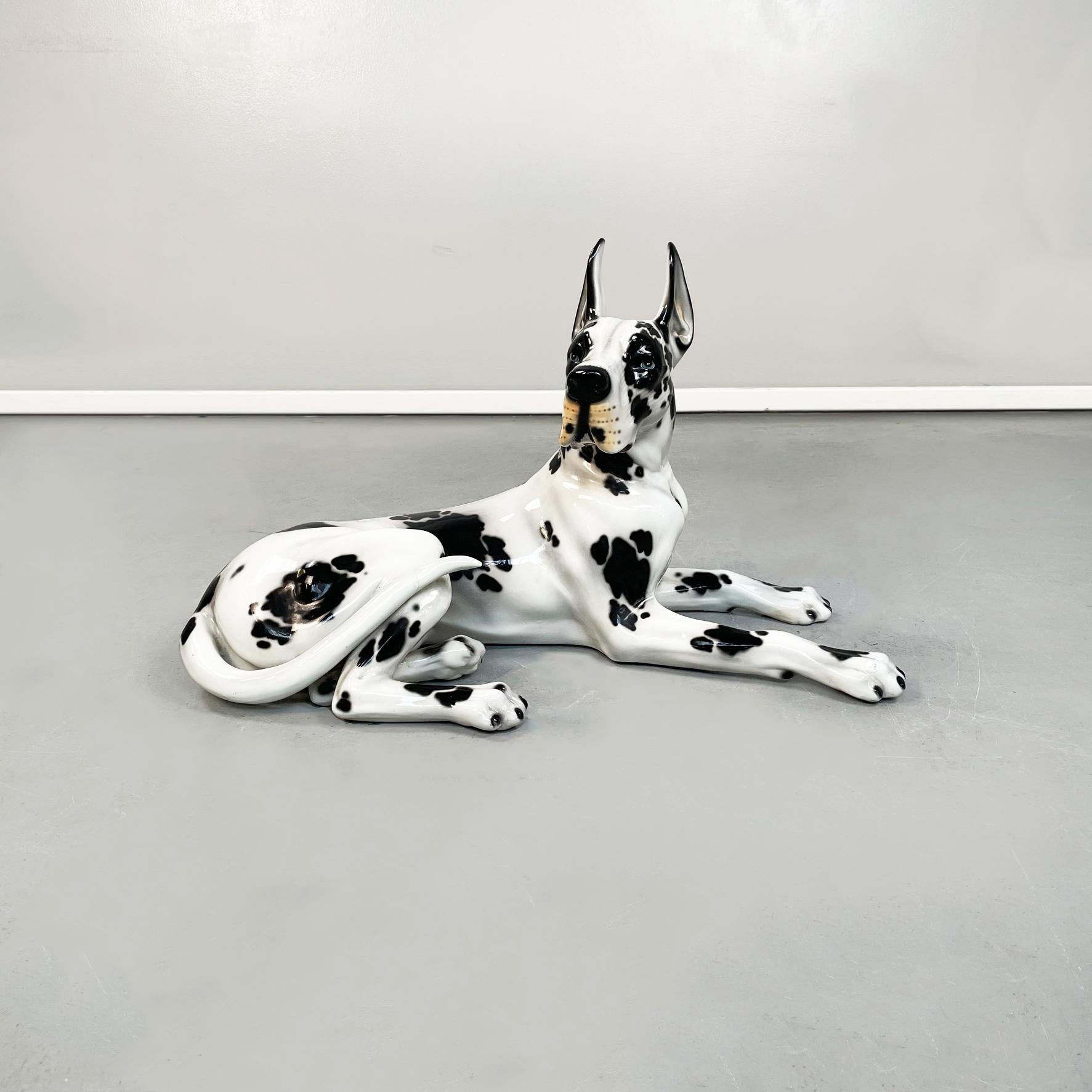Italian late 20th century Black and white ceramic alano dog sculpture, 1970s
Alano dog lying down sculpture in white ceramic with black spots. Finely worked.
1970s.
Good conditions, with cracks and re-glued parts.
Measurements in cm 85 x 43 x 51 H.