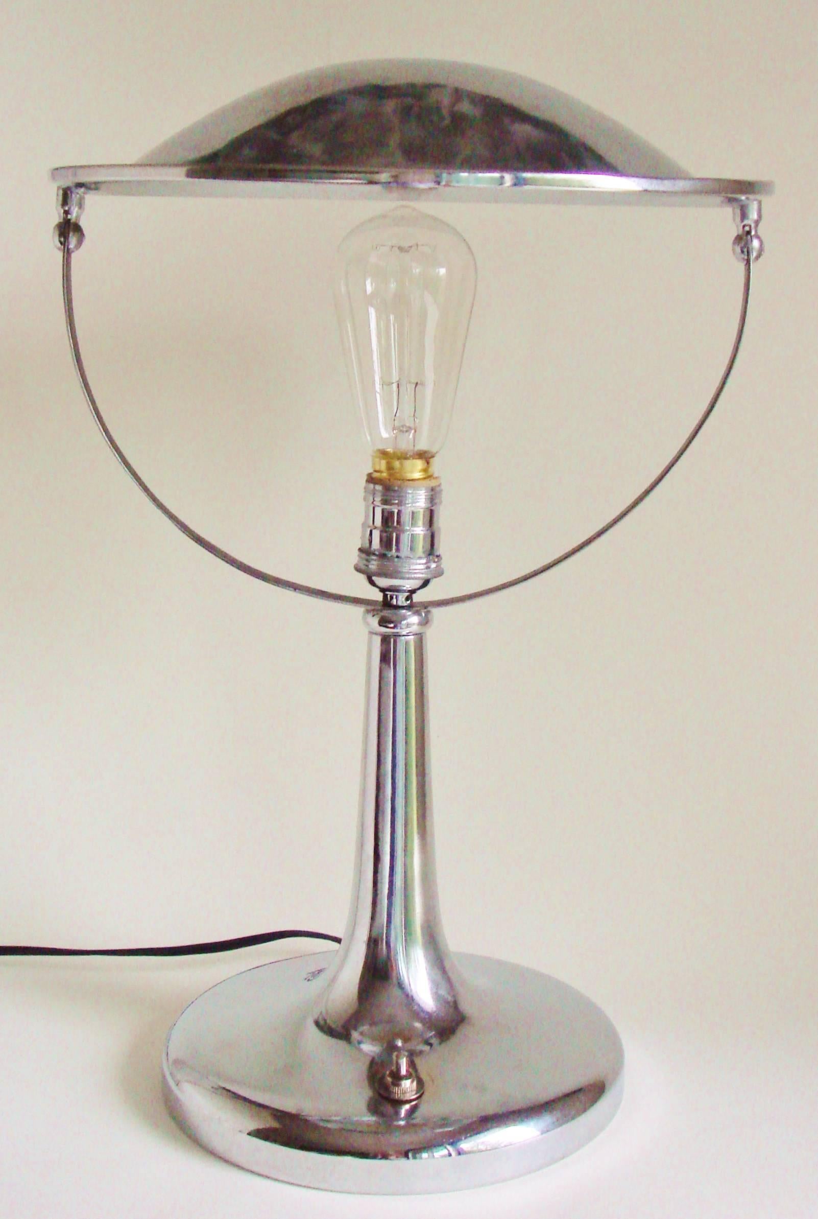 This intriguingly designed adjustable shade desk or table lamp was manufactured in the years post World War II by the Italian electrical company, Zerowatt and its design is credited to Gardoncini. The chrome is in excellent condition and, at some