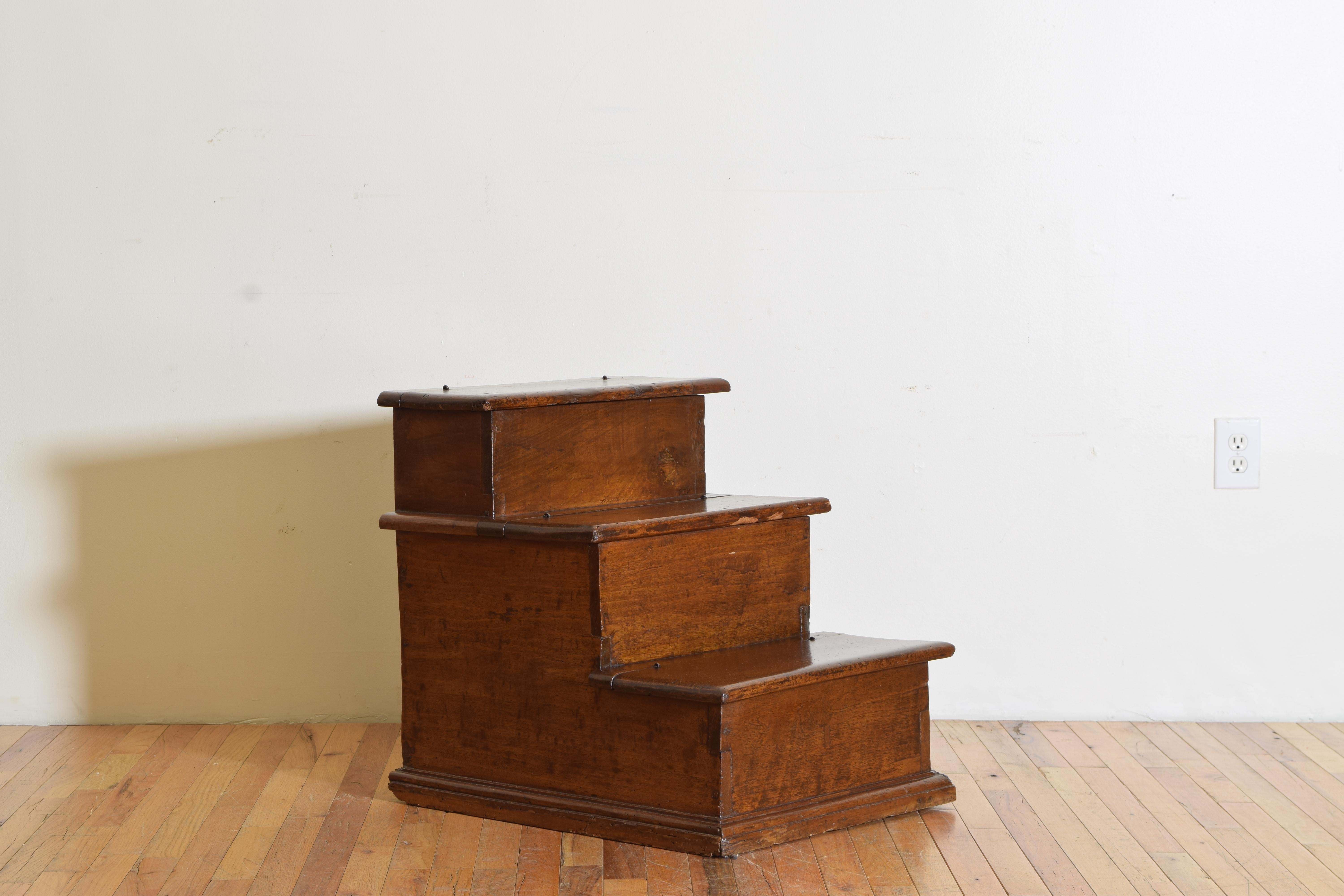 Highly functional and useful library steps with a wonderful patina, having three shaped steps with molded edges raised on a plinth-form base, each hinged step lifting to reveal a storage compartment.
