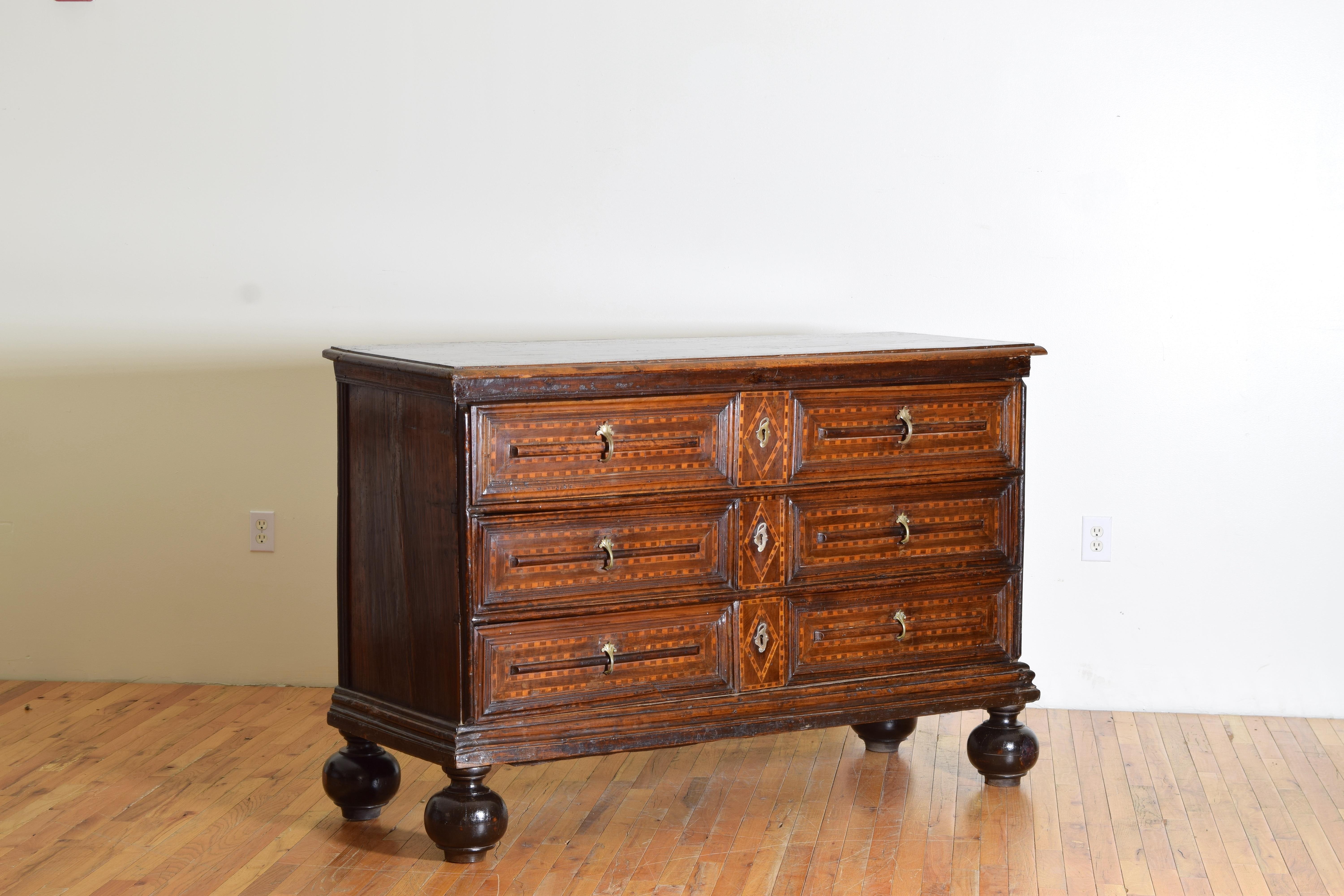 Constructed in the village of Bassano del Grappa in the Veneto region of Italy this rare and exceptional commode has a rectangular top with a modest molded edge atop a conforming case housing three drawers all with alternating rectangular inlays of