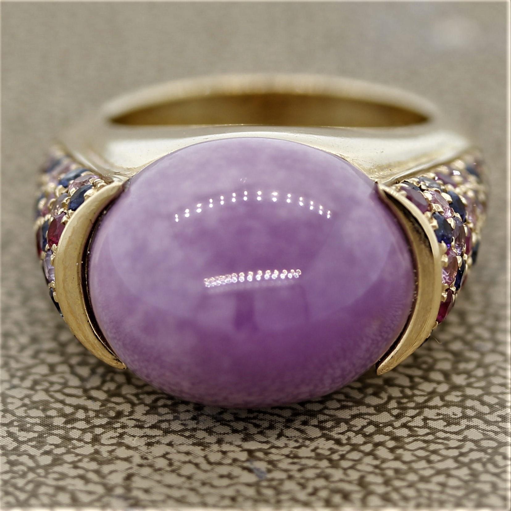 A lovely domed ring hand-crafted in Italy. It features a natural 17.50 carat cabochon jadeite jade with a luscious lavender color. It is accented by 1.90 carats of round cut rubies and multi-color sapphires set on the shoulders of the ring. Expertly