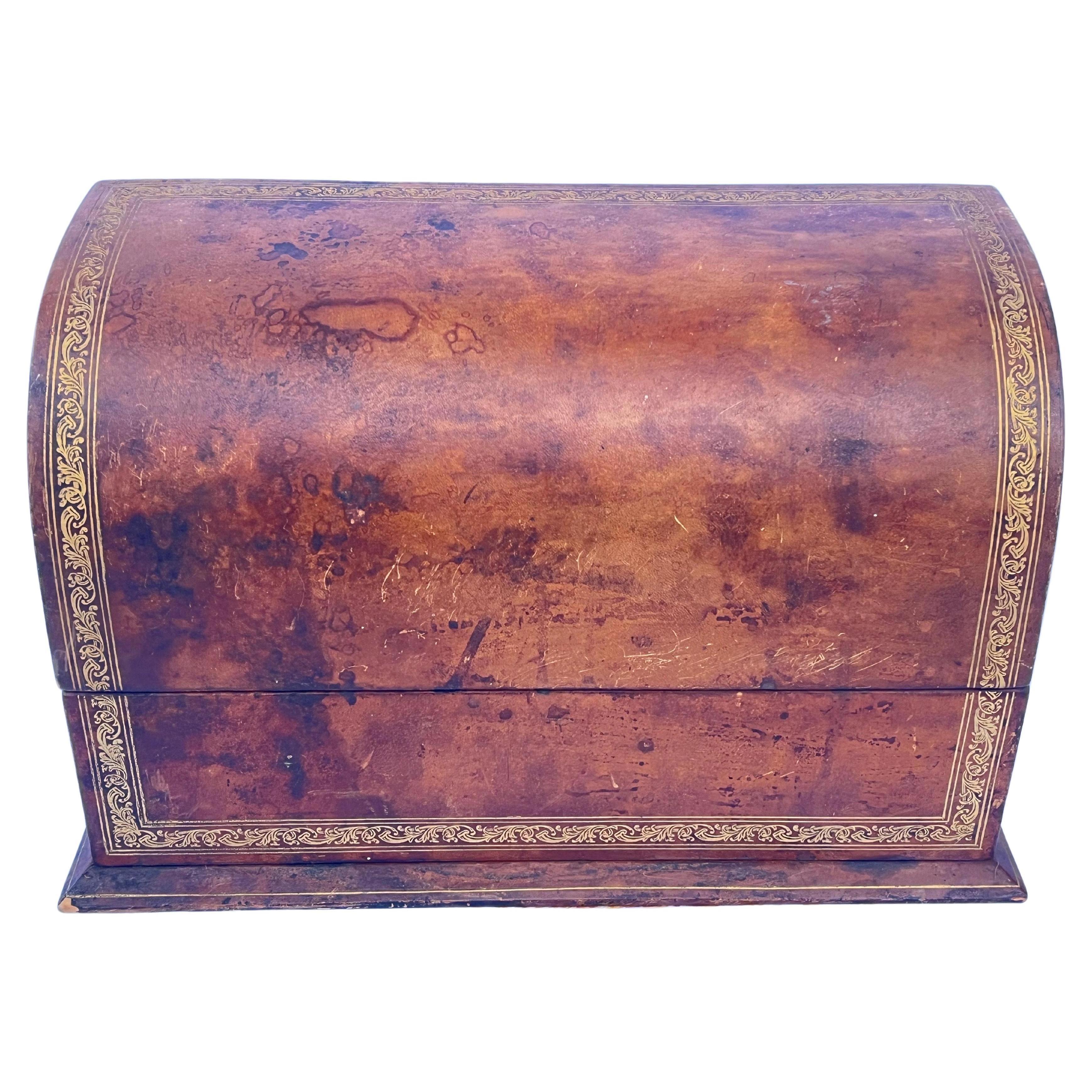 A vintage mid twentieth century Italian leather and gold leaf design half dome letter box or desk accessory. Gorgeous, worn and well loved patina. Lined in a beautiful orange-y fabric. The cigar / chocolate brown leather exterior is regal and