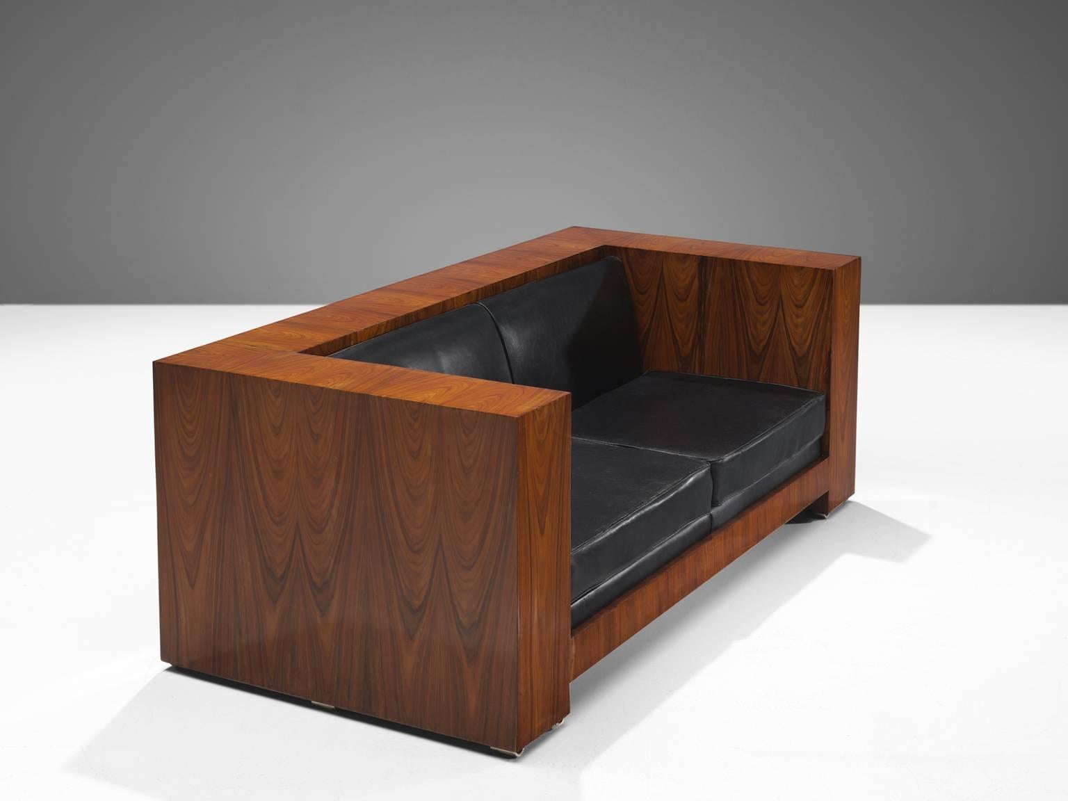 Settee, black leather, rosewood, Italy, circa 1965

This two-seat 'basket' sofas is designed around 1965. The two-seat leather cushions fall perfectly in the rosewood frame. The design of this sofa is very geometric as the sides of the sofa are