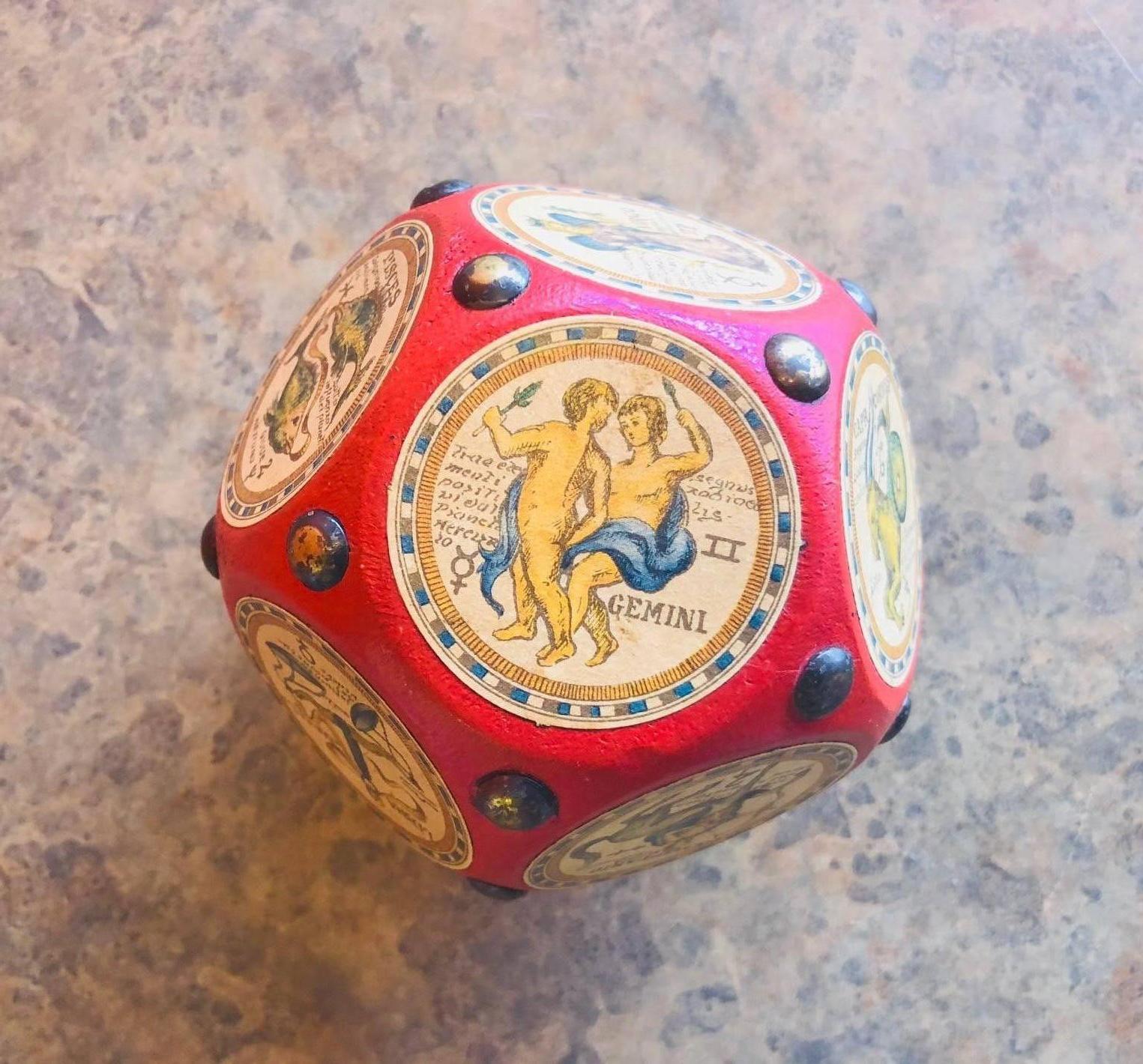 A rare Italian dodecahedron paperweight with the 12 signs of the Zodiac prominently displayed. The astrological signs are beautifully illustrated and the writing appears to be in Latin or Italian; each picture is a well crafted celestial
