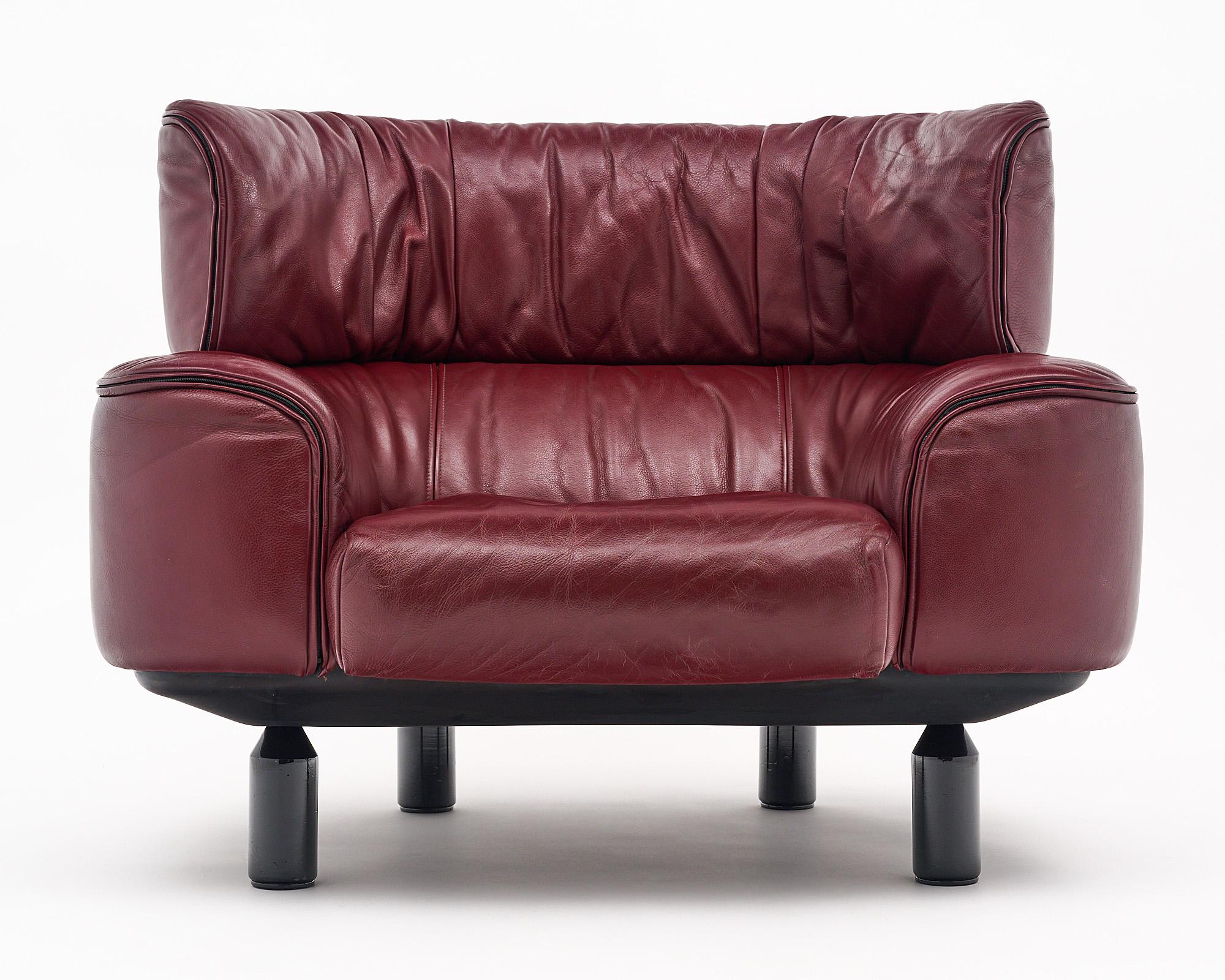 Pair of armchairs designed by Gianfranco Frattini for Cassina. This pair is made with red leather and has the Cassina signature on the backside of the seat pillows. We love the comfort; size; and style of this pair.