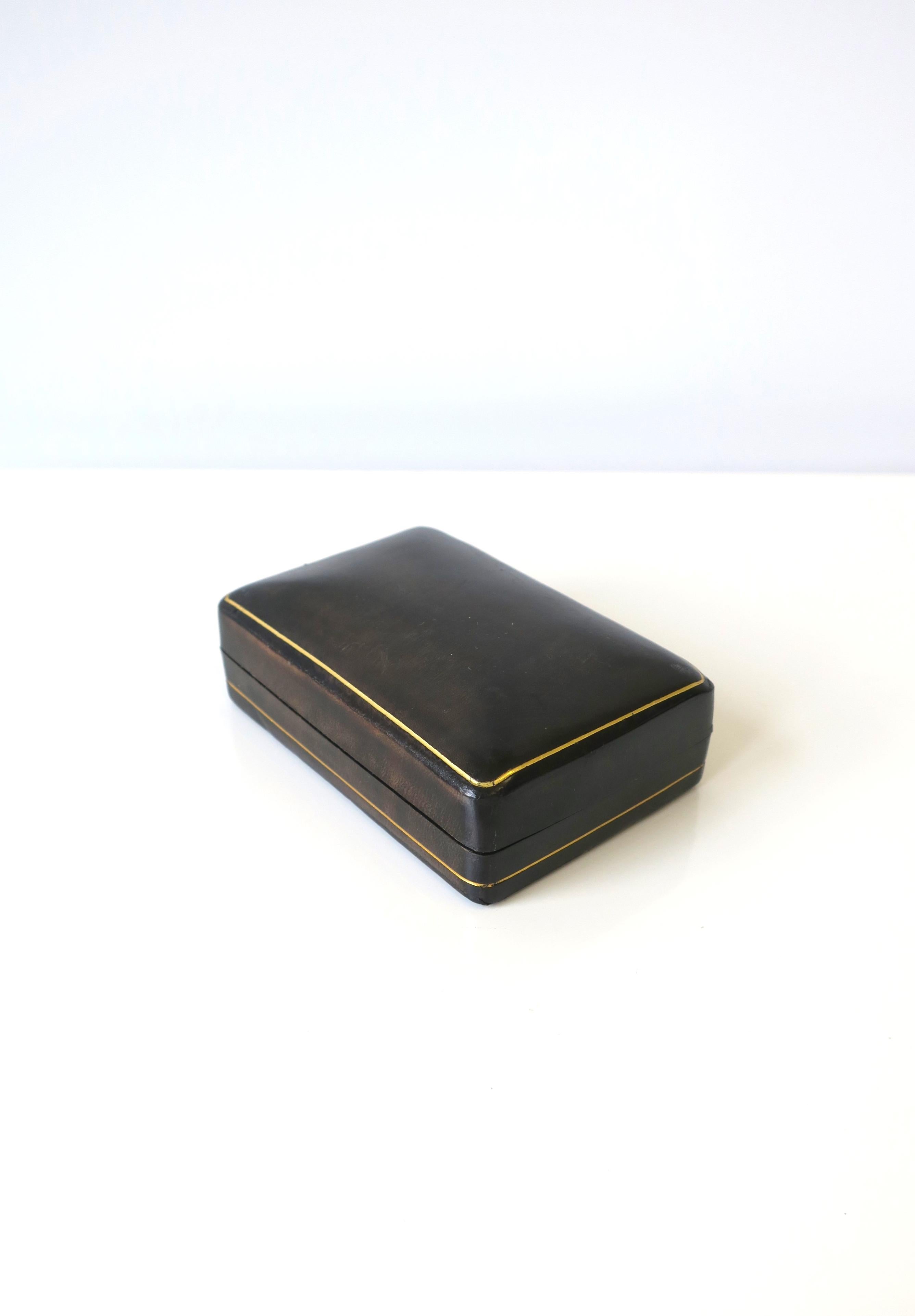 A very beautiful vintage Italian all leather jewelry box in dark grey charcoal with gold embossing, circa mid-20th century, Italy. Marked 
