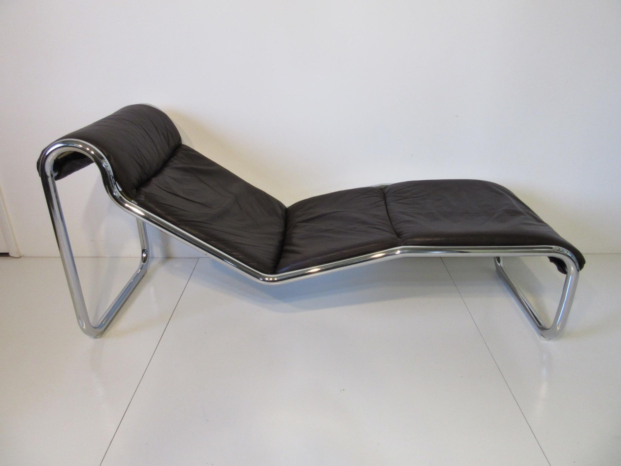A sleek, stylish Italian chaise lounger - daybed with sculptural chrome tube frame covered in soft and rich brown leather, nylon glides to the bottom will protect your floors. This is the most comfortable lounger will have ever had, ergonomic