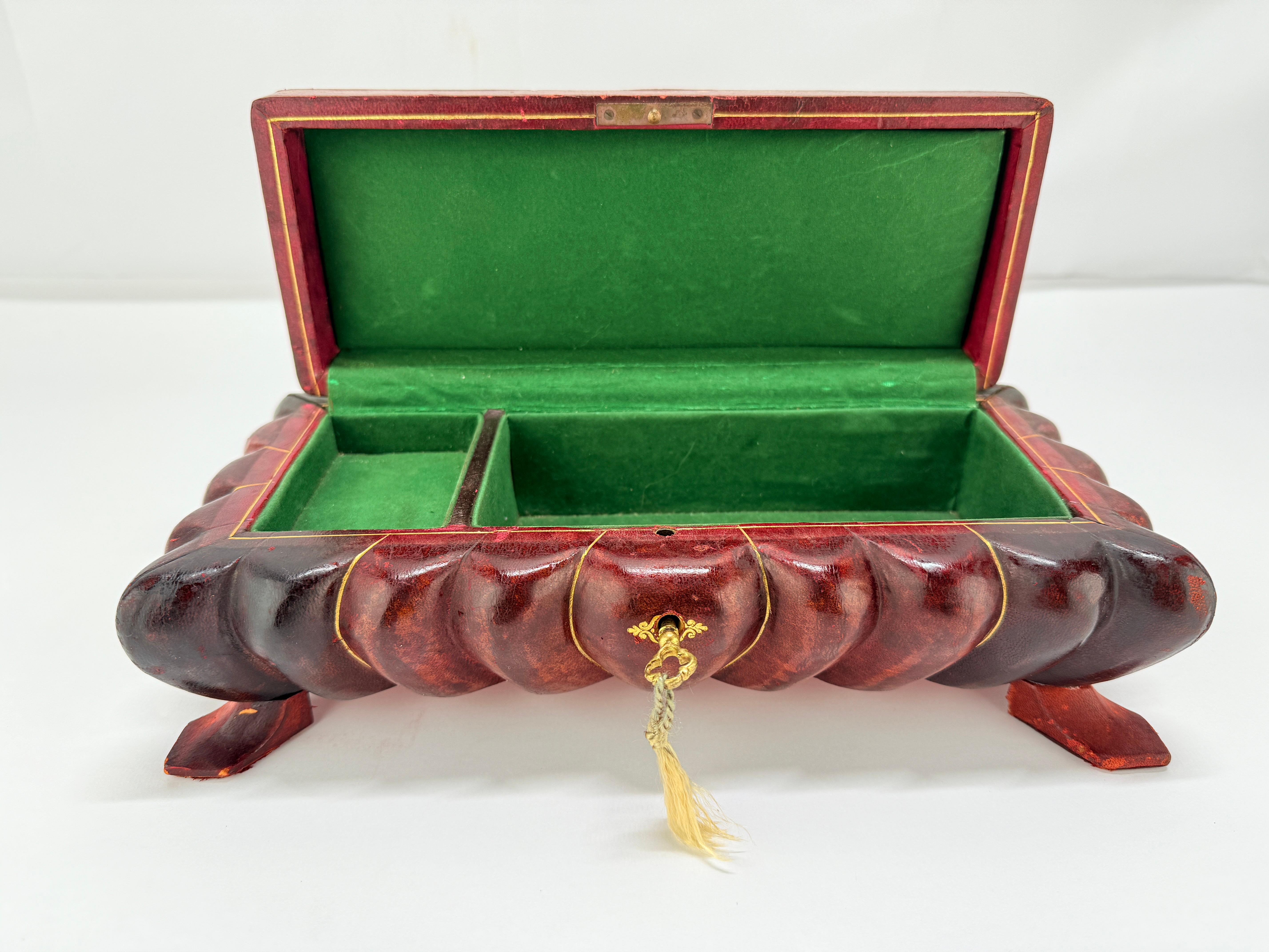 **Italian Leather-Clad and Gilt-Tooled Tabletop Jewelry or Trinket Box, Mid-20th Century**

This unusually sculptural leather-covered box, marked *Made in Italy and Makers address Pelletterie Firenze* on its underside, reflects the high